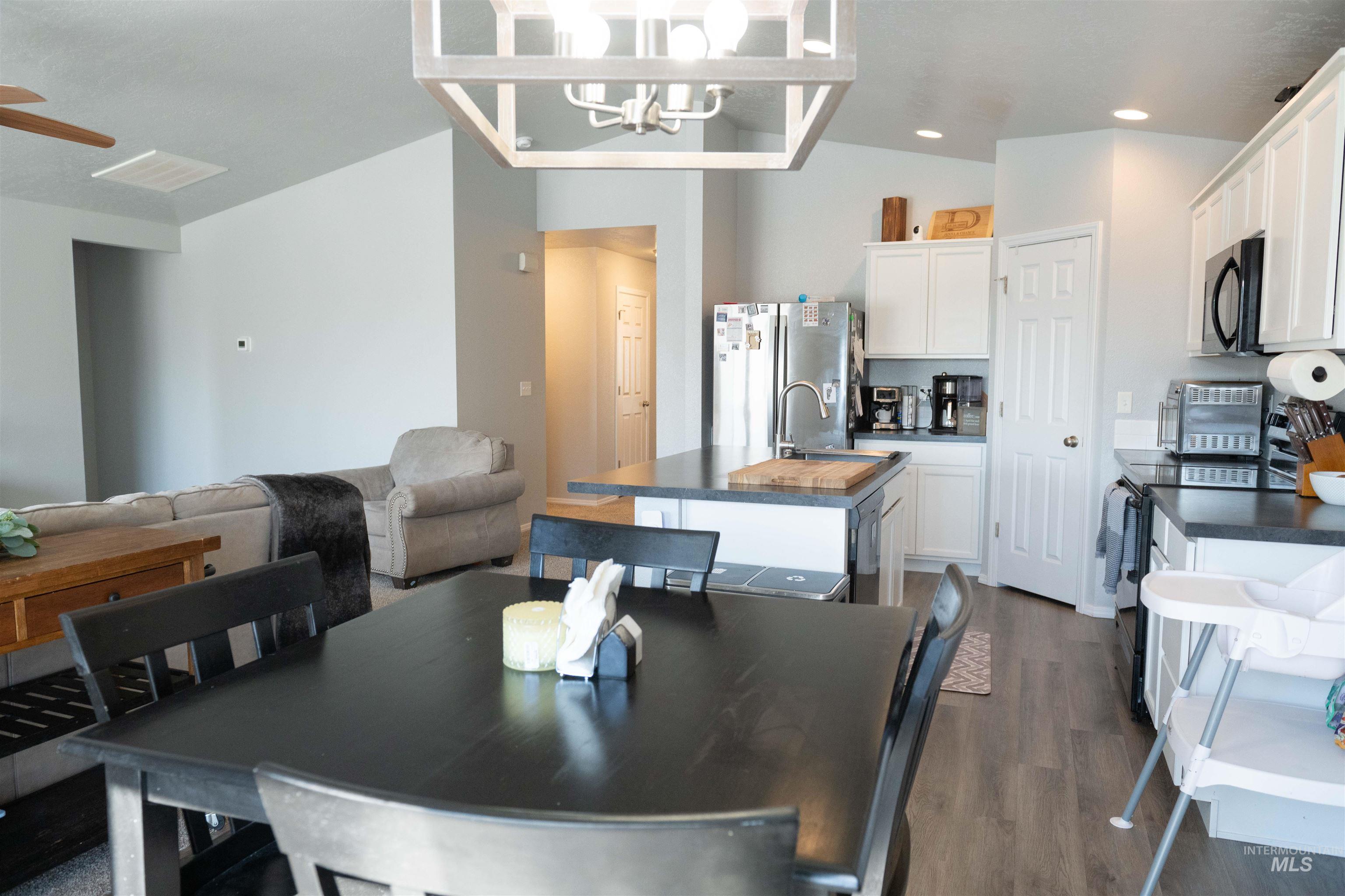 Dining room featuring dark wood-style floors, a chandelier, and recessed lighting