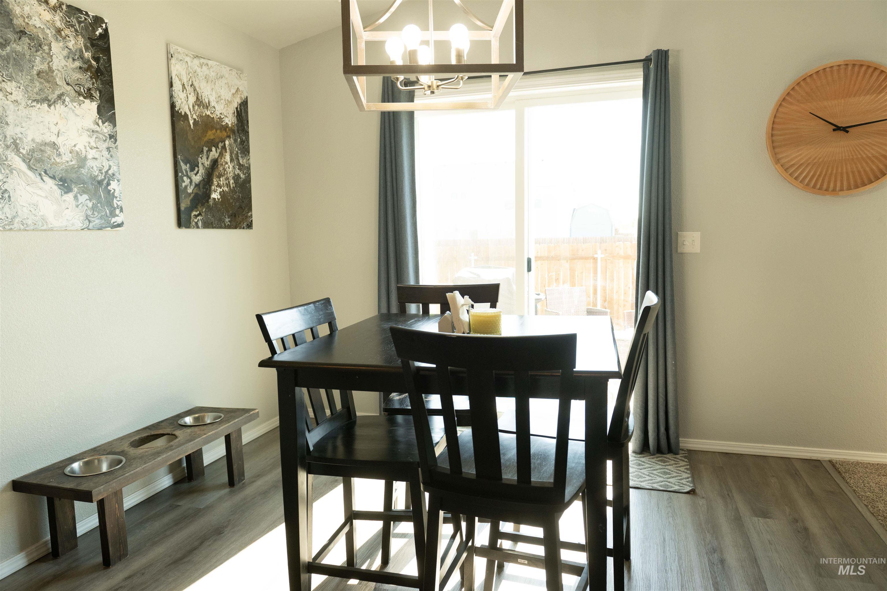 Dining area featuring a chandelier and wood finished floors