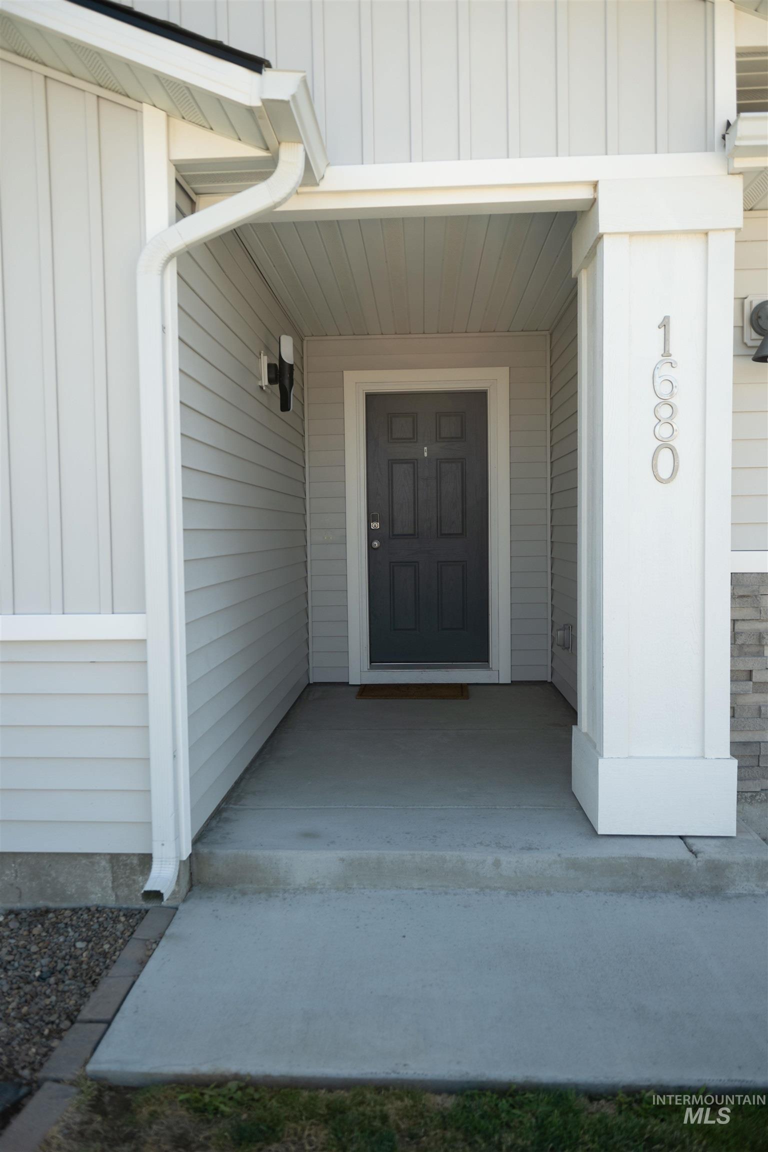 Doorway to property with board and batten siding