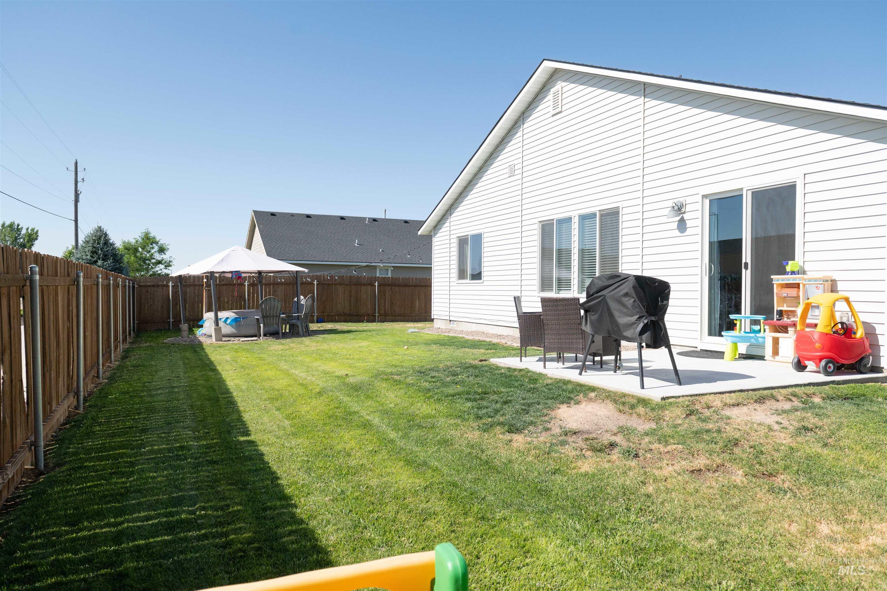 Back of property with a patio area and a fenced backyard