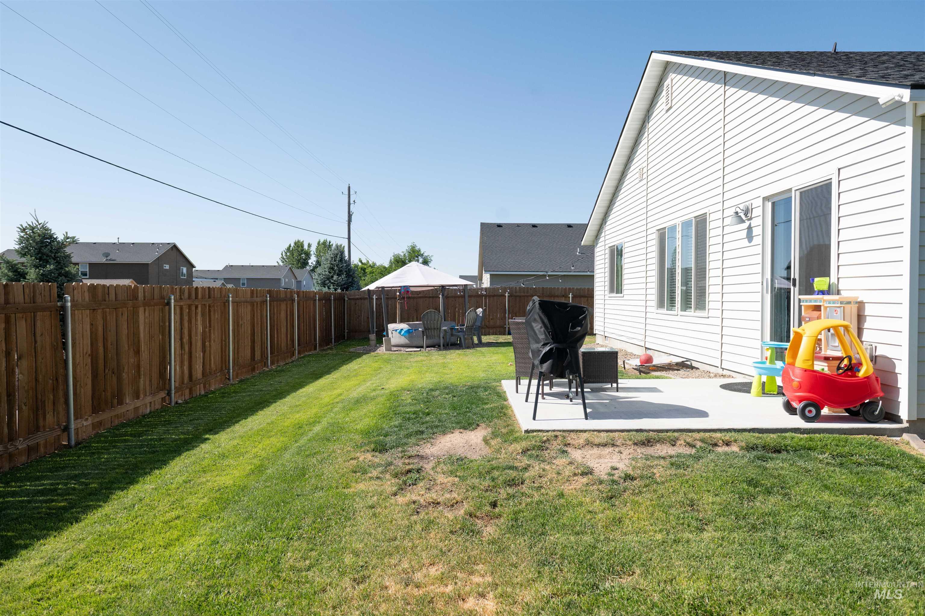 Fenced backyard with a patio