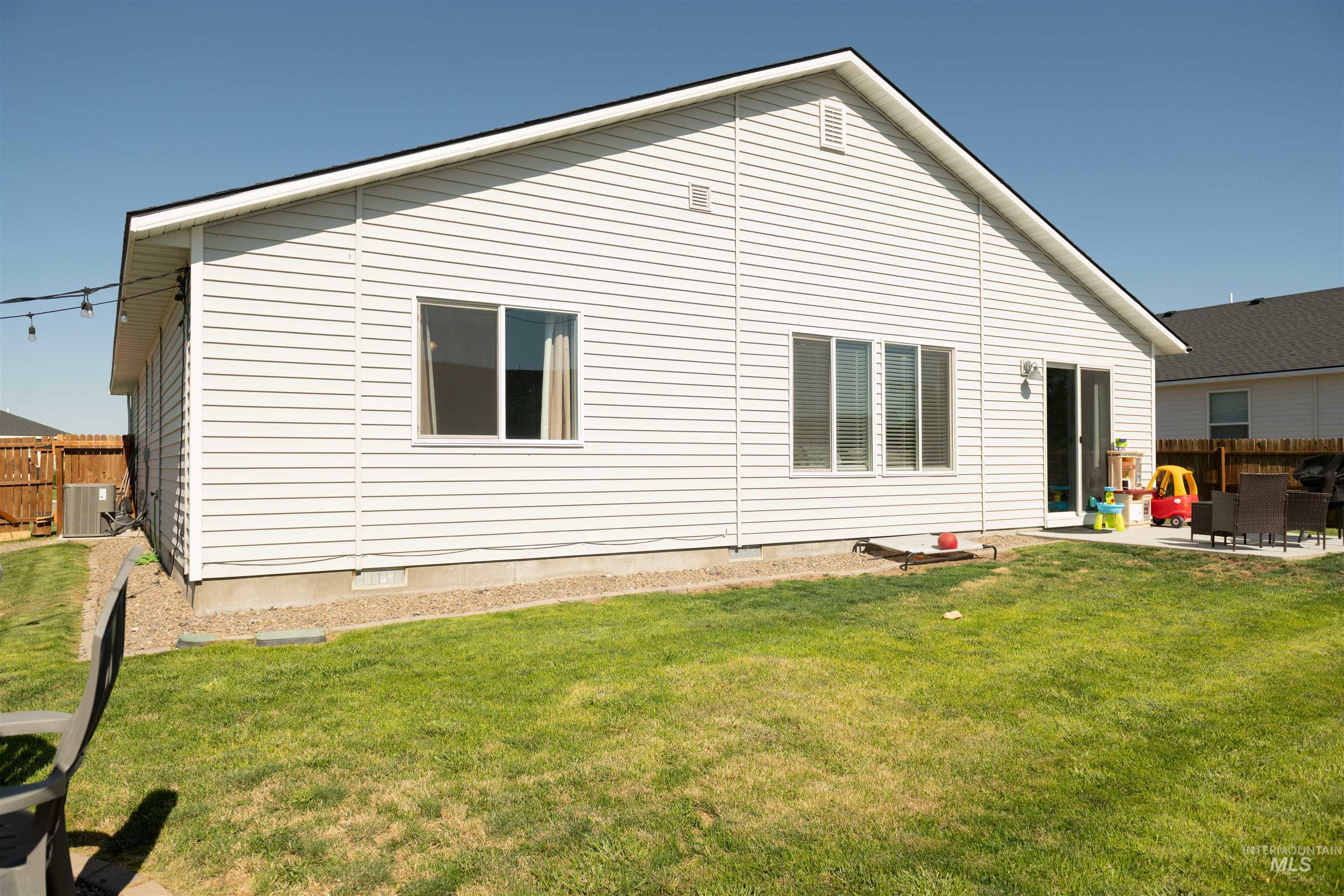 Rear view of property featuring a patio area and crawl space
