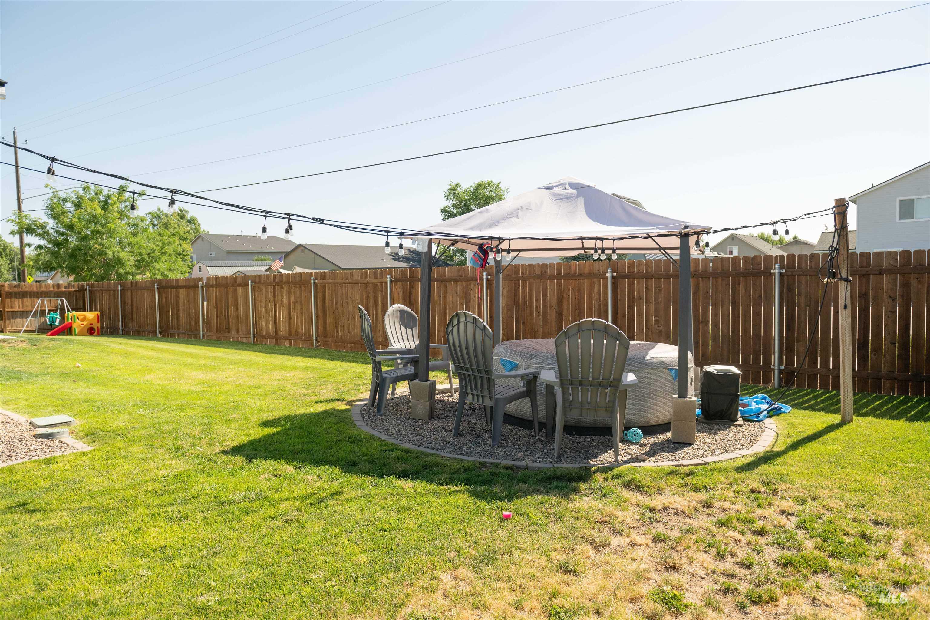 Fenced backyard with a gazebo