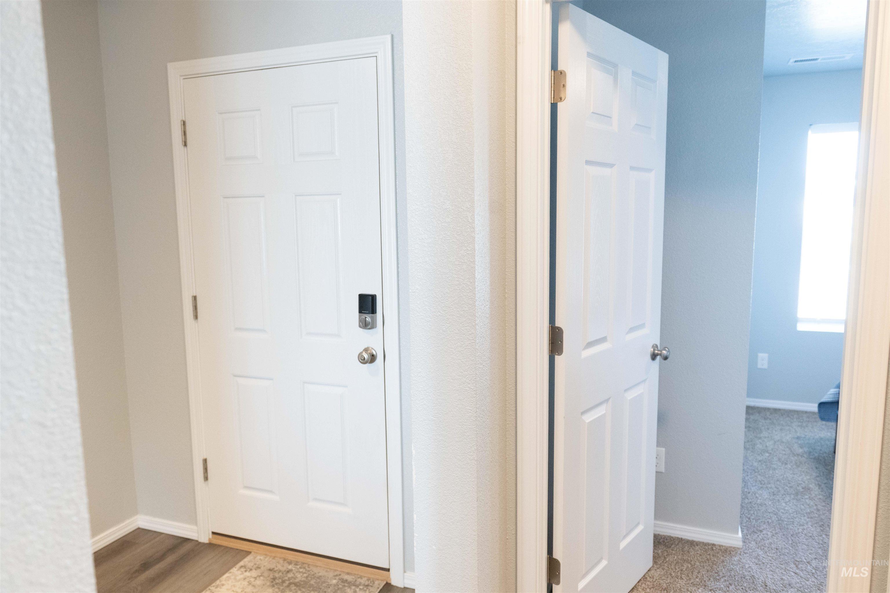 Hall with baseboards and wood finished floors