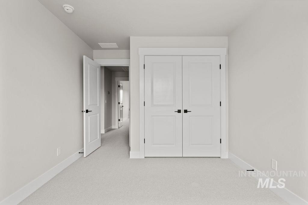 Unfurnished bedroom with carpet flooring and a closet