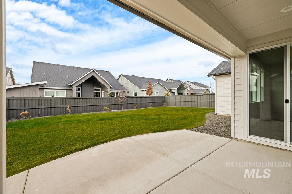 Fenced backyard with a patio and a residential view