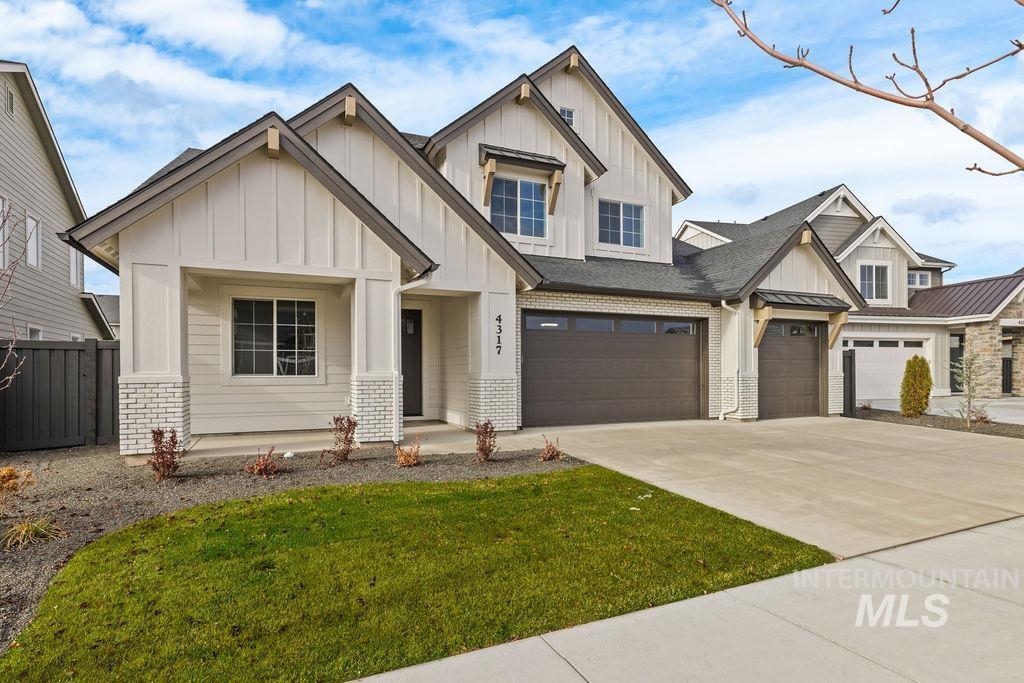 View of front of property with brick siding, board and batten siding, concrete driveway, a garage, and a shingled roof