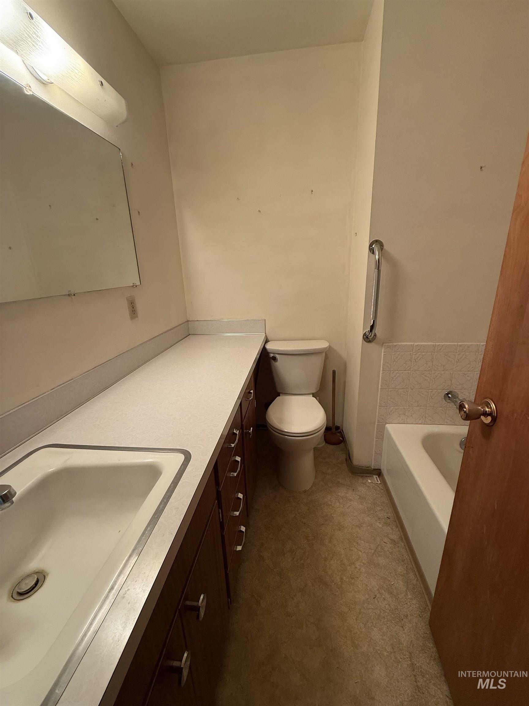 Full bathroom featuring vanity and a bath