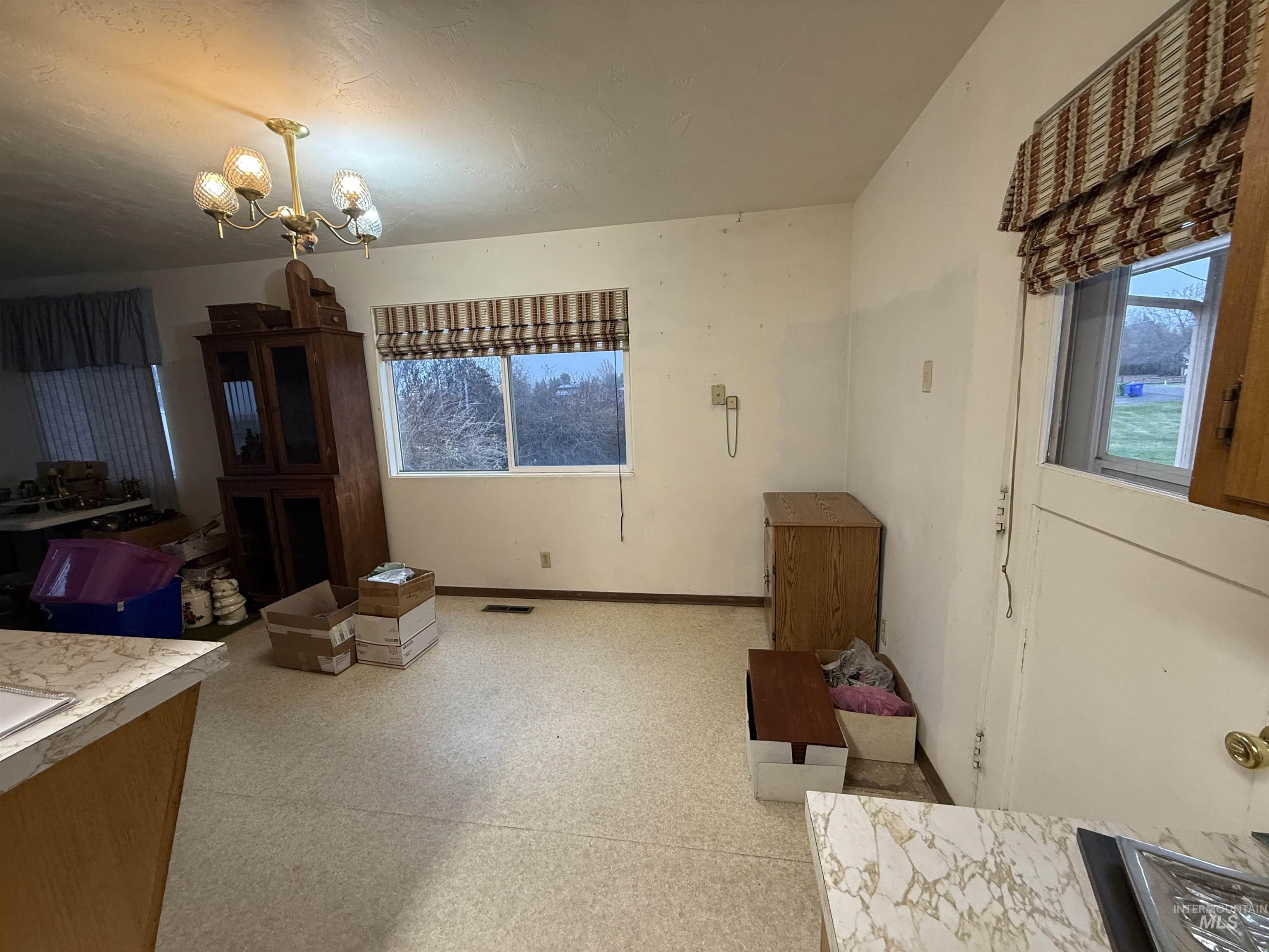 Interior space with a chandelier and light floors