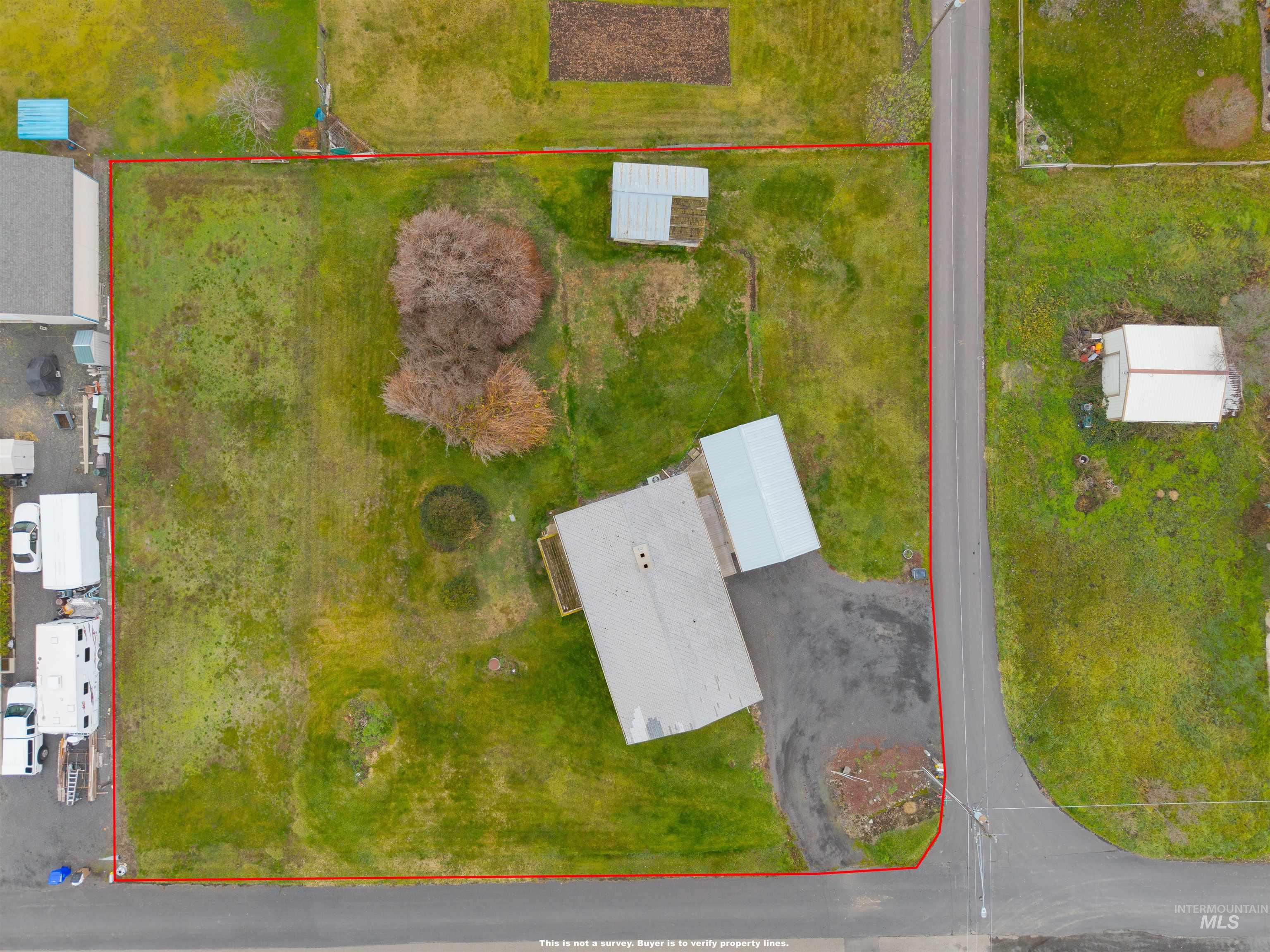 Aerial view of property and surrounding area with property parcel outlined
