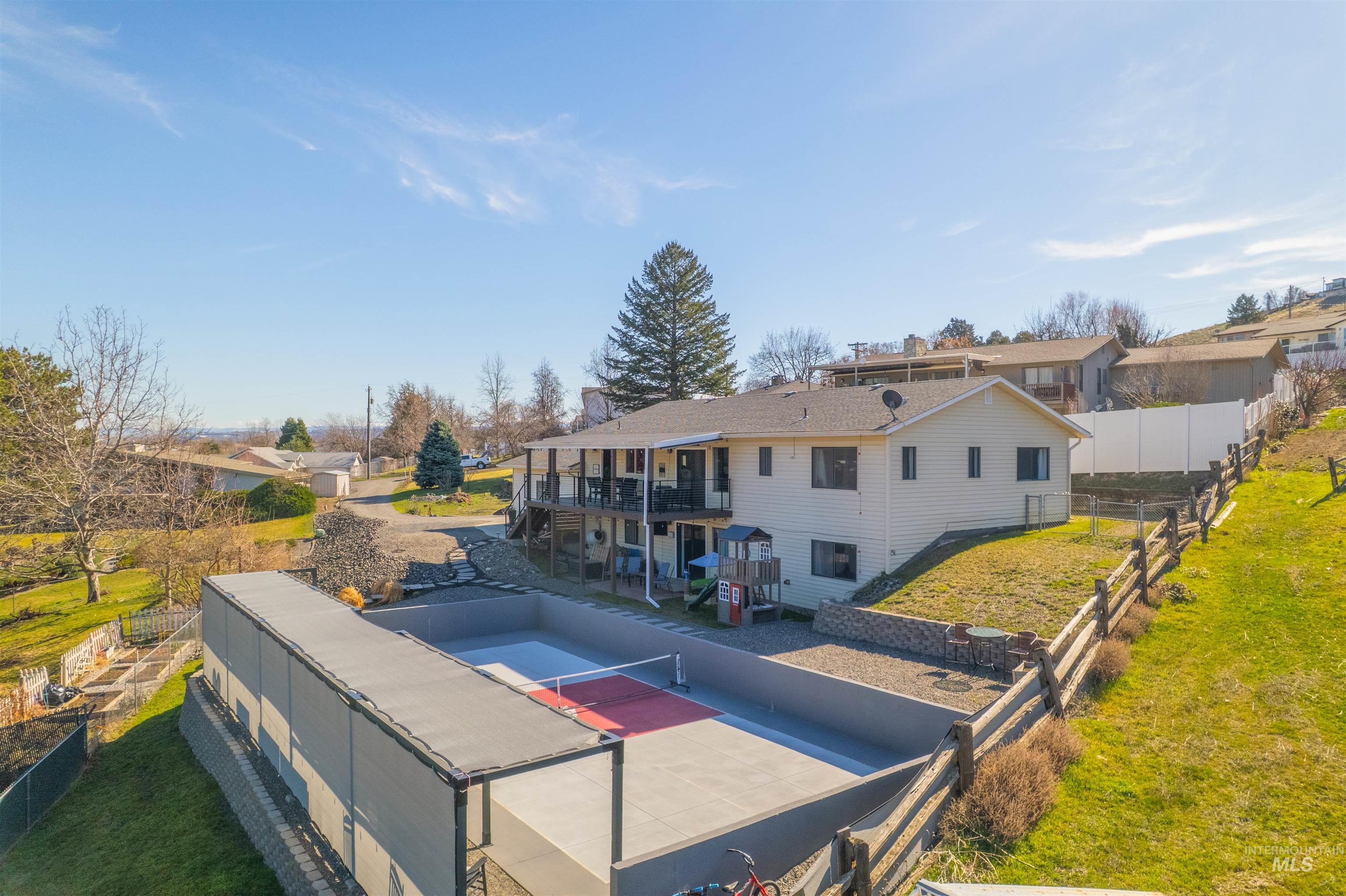 Back of house with a patio area, a balcony, and a residential view