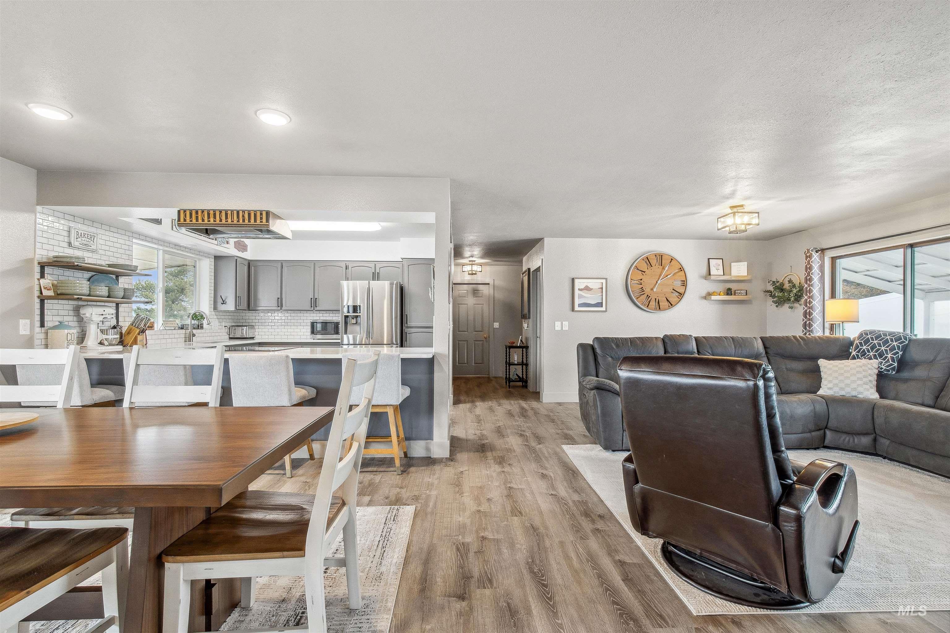 Dining space with light wood-style flooring and baseboards