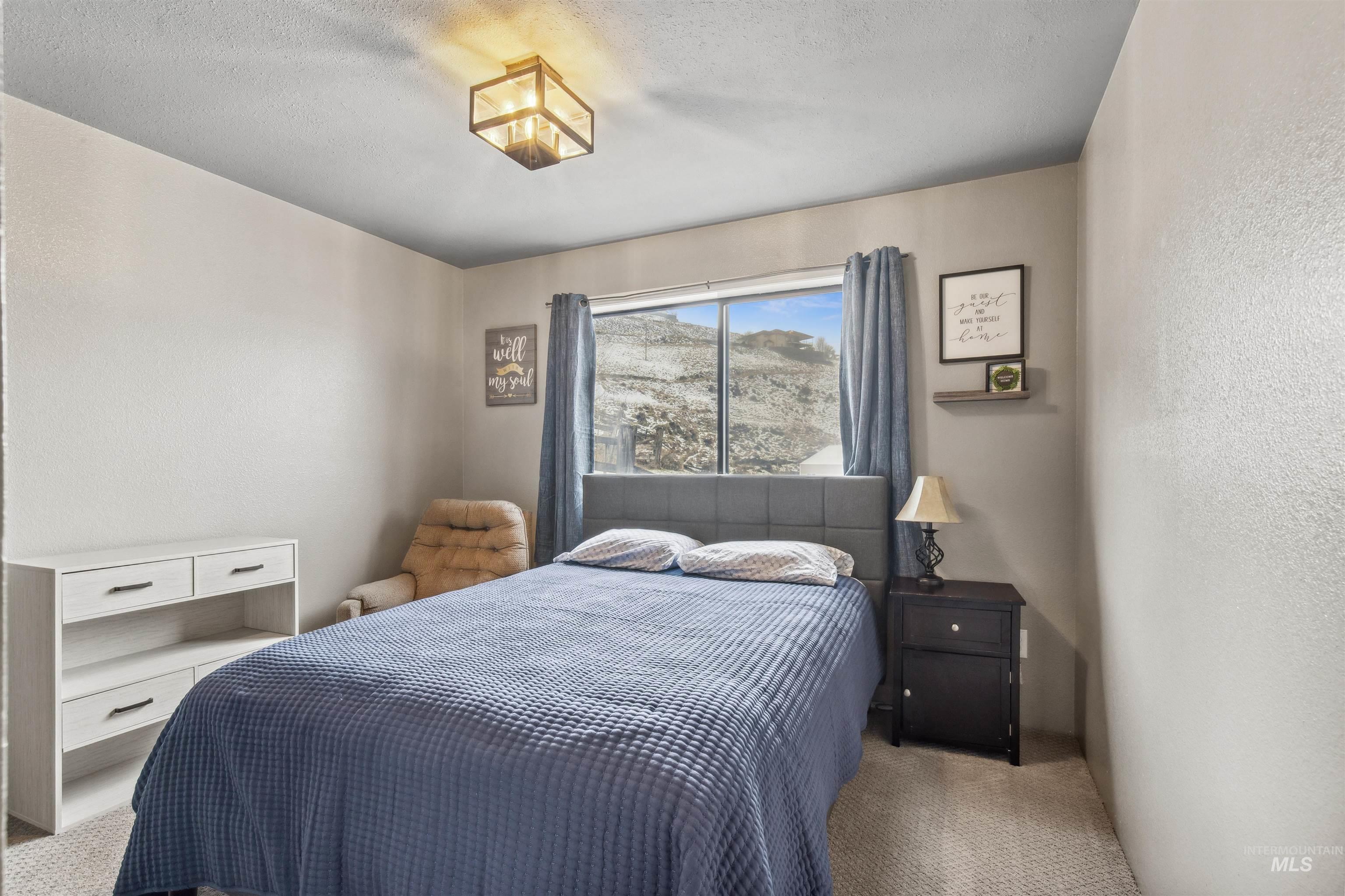 Carpeted bedroom with a textured wall