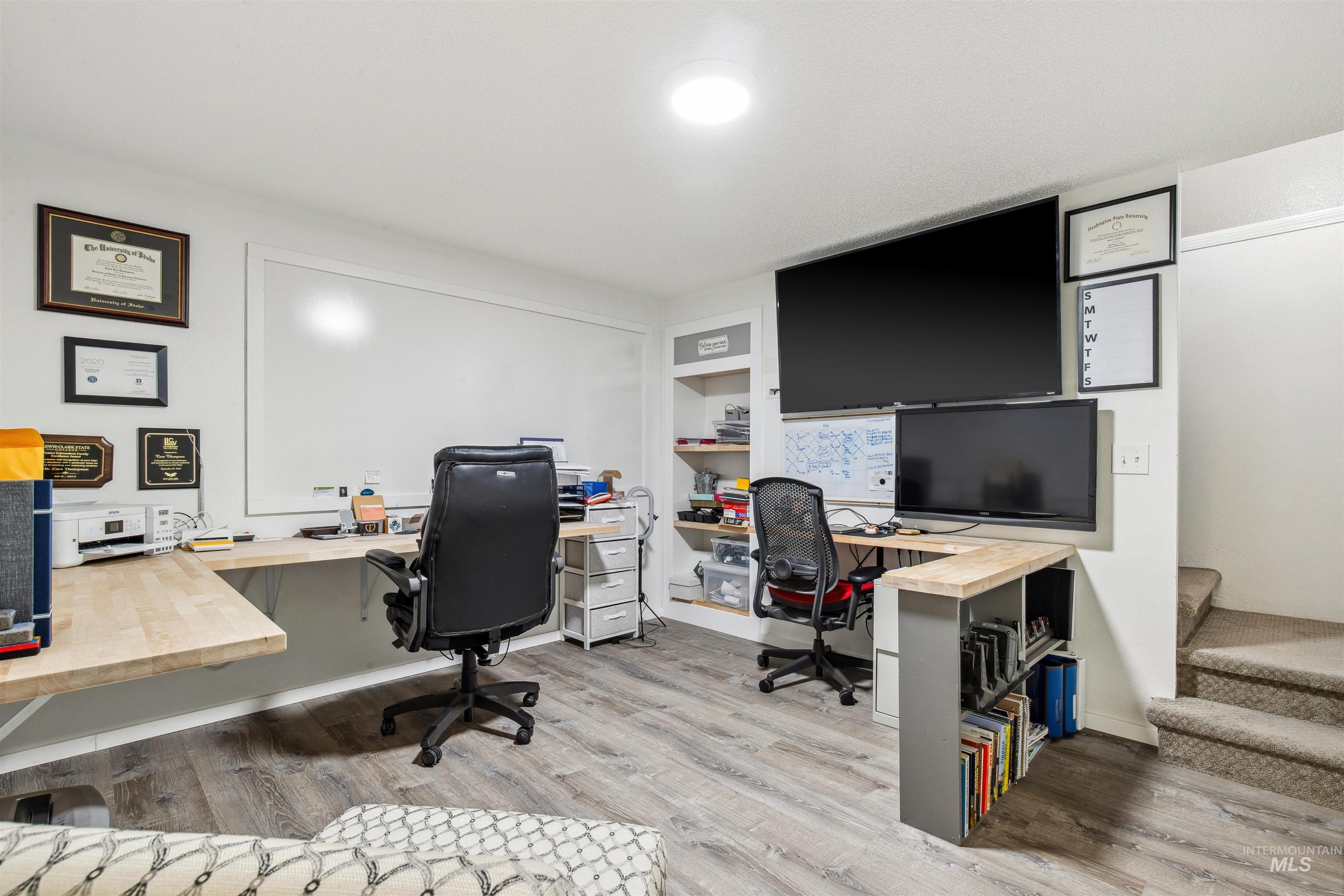 Home office featuring light wood-style flooring and built in features