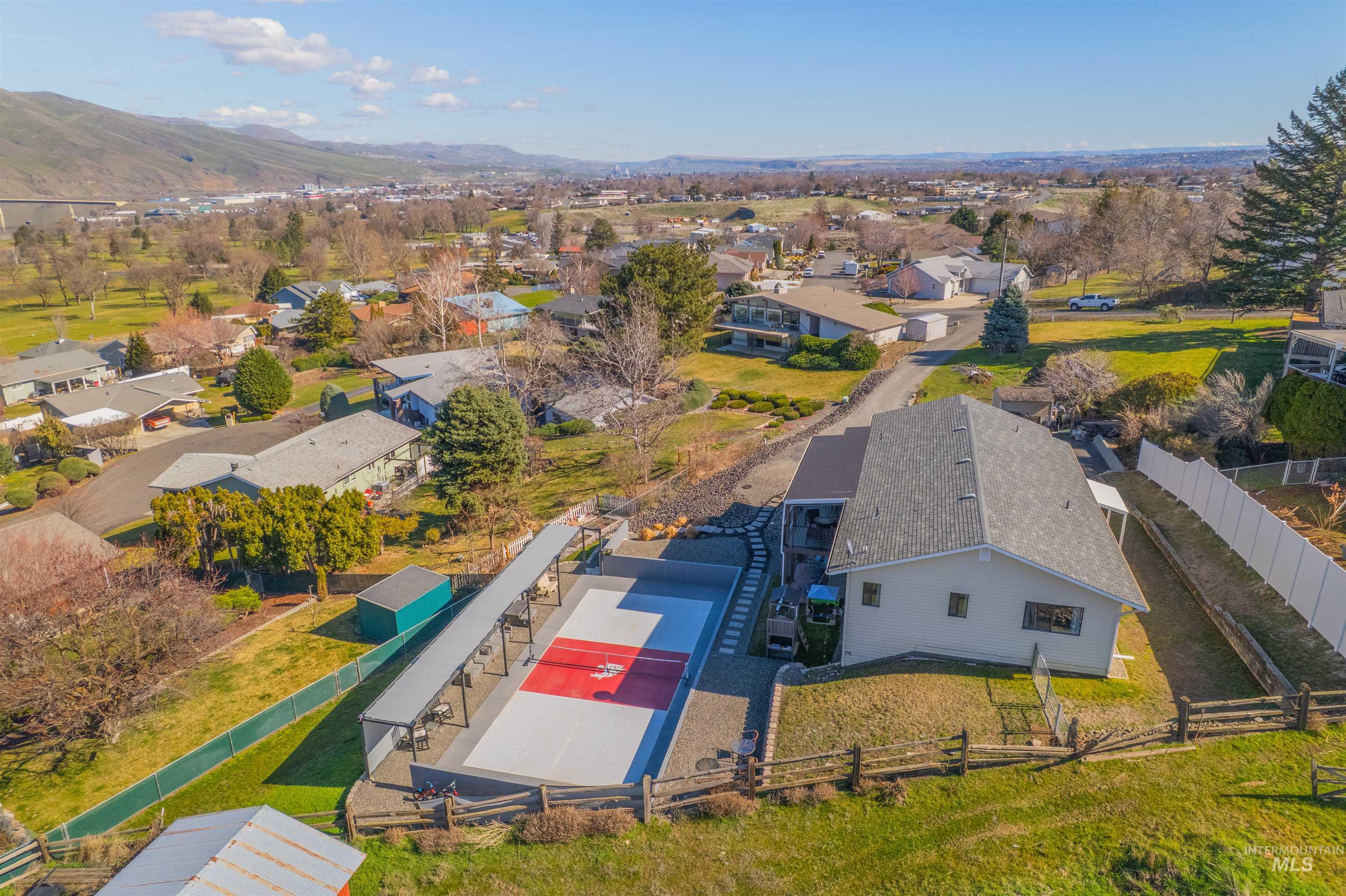 Aerial view of residential area featuring a mountainous background