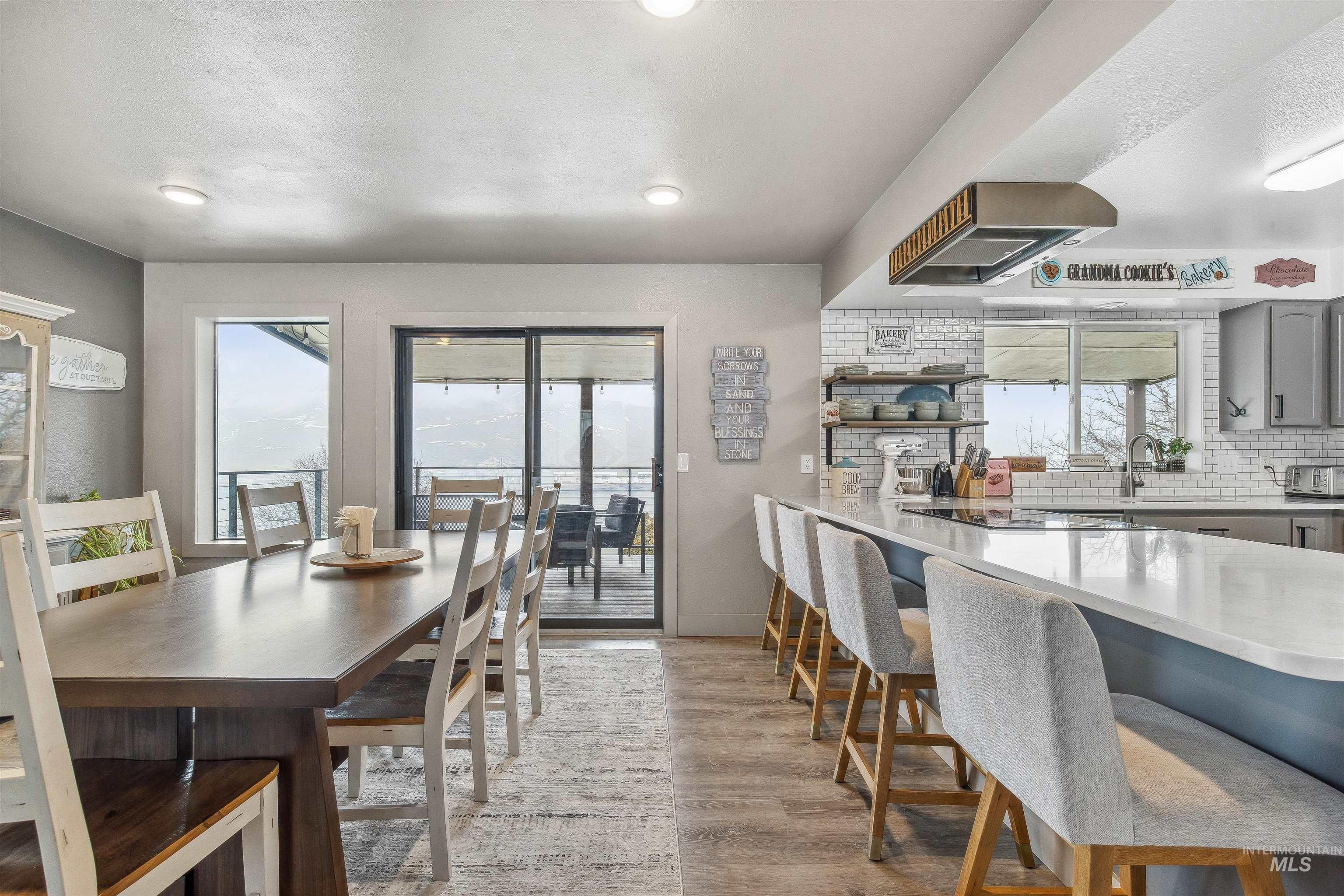 Dining room with light wood finished floors and recessed lighting