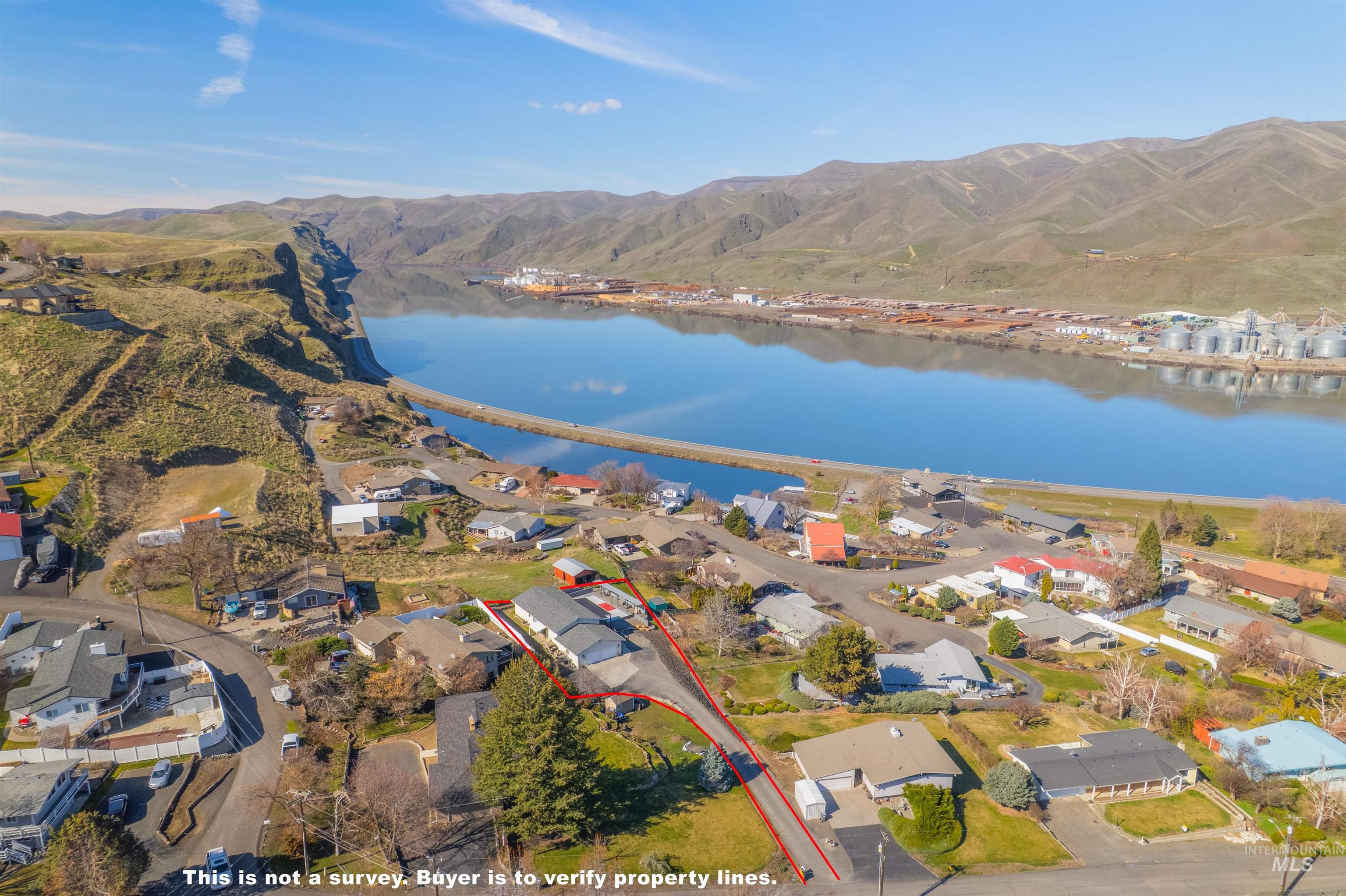 Aerial overview of property's location featuring nearby suburban area and a water and mountain view