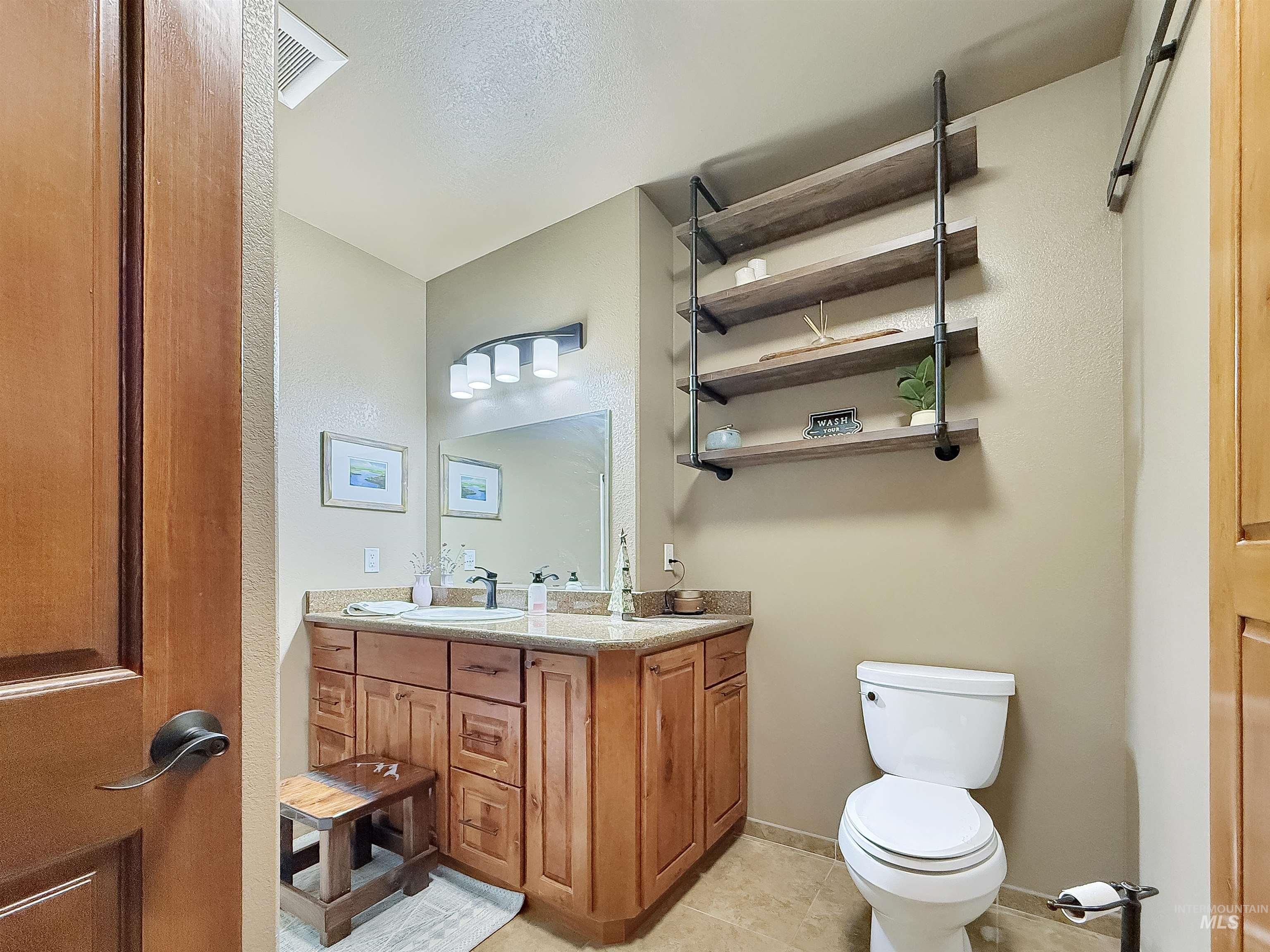 Bathroom with vanity and light tile patterned floors