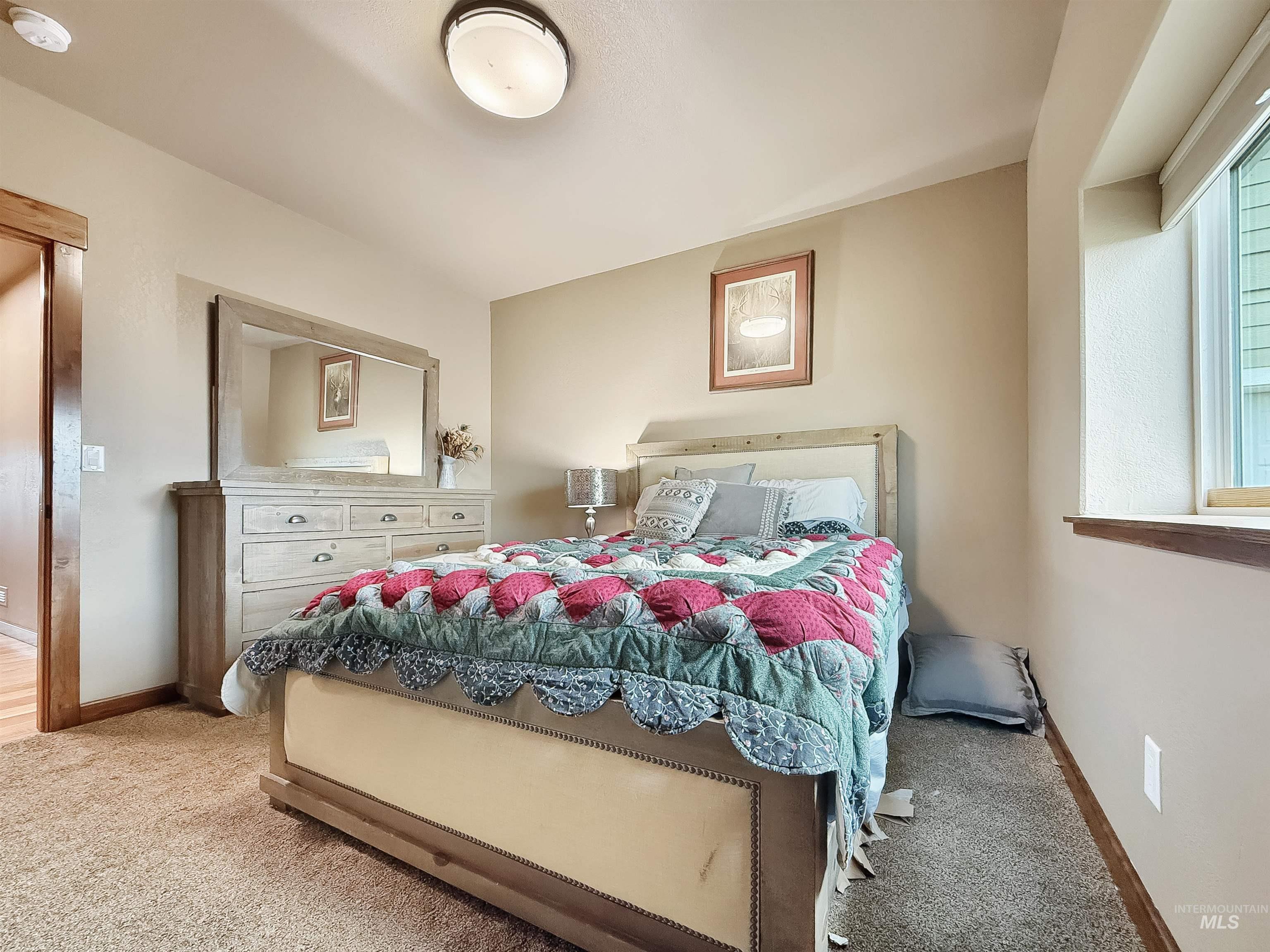 Carpeted bedroom with baseboards