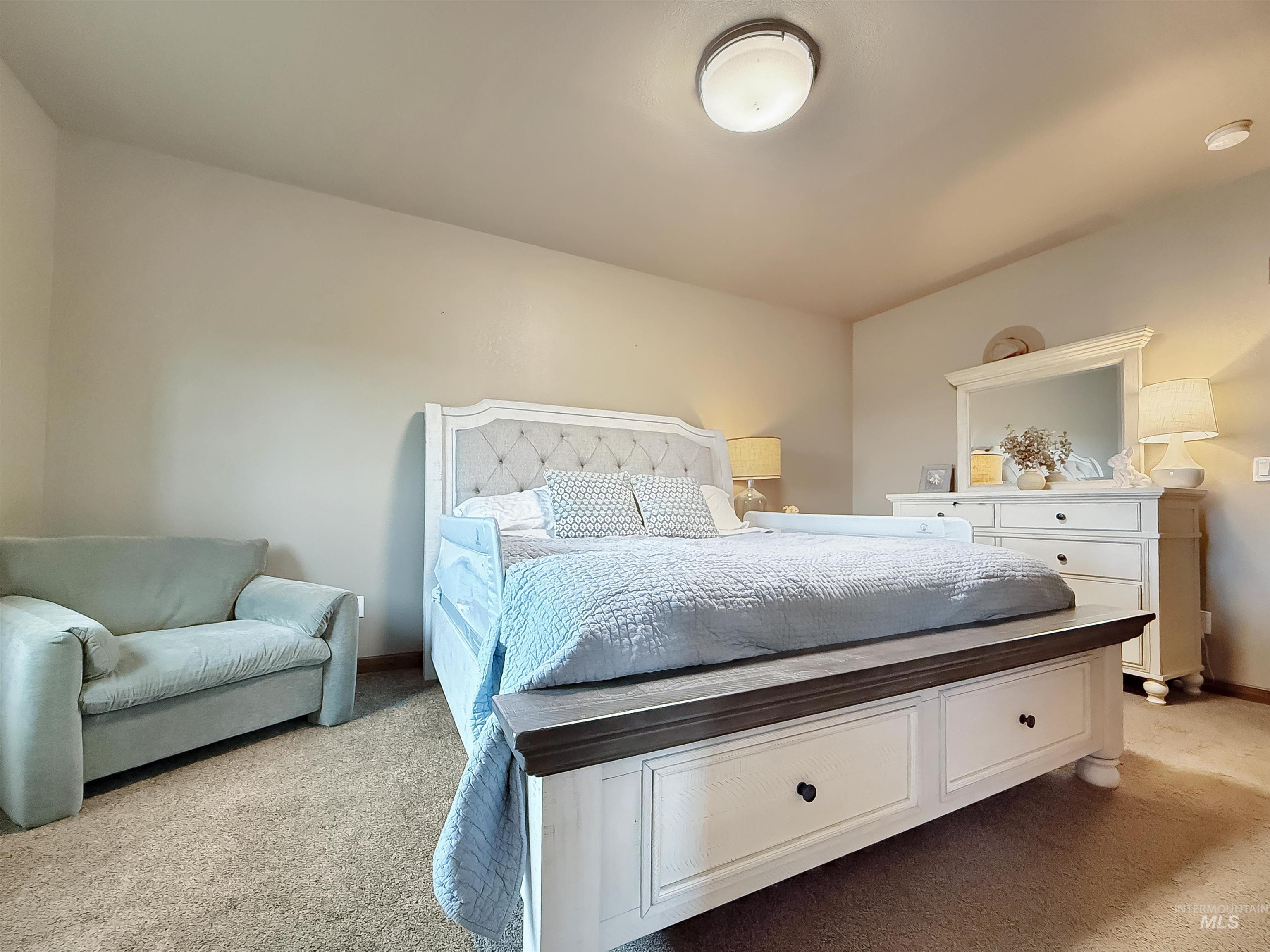 Bedroom featuring light colored carpet and baseboards