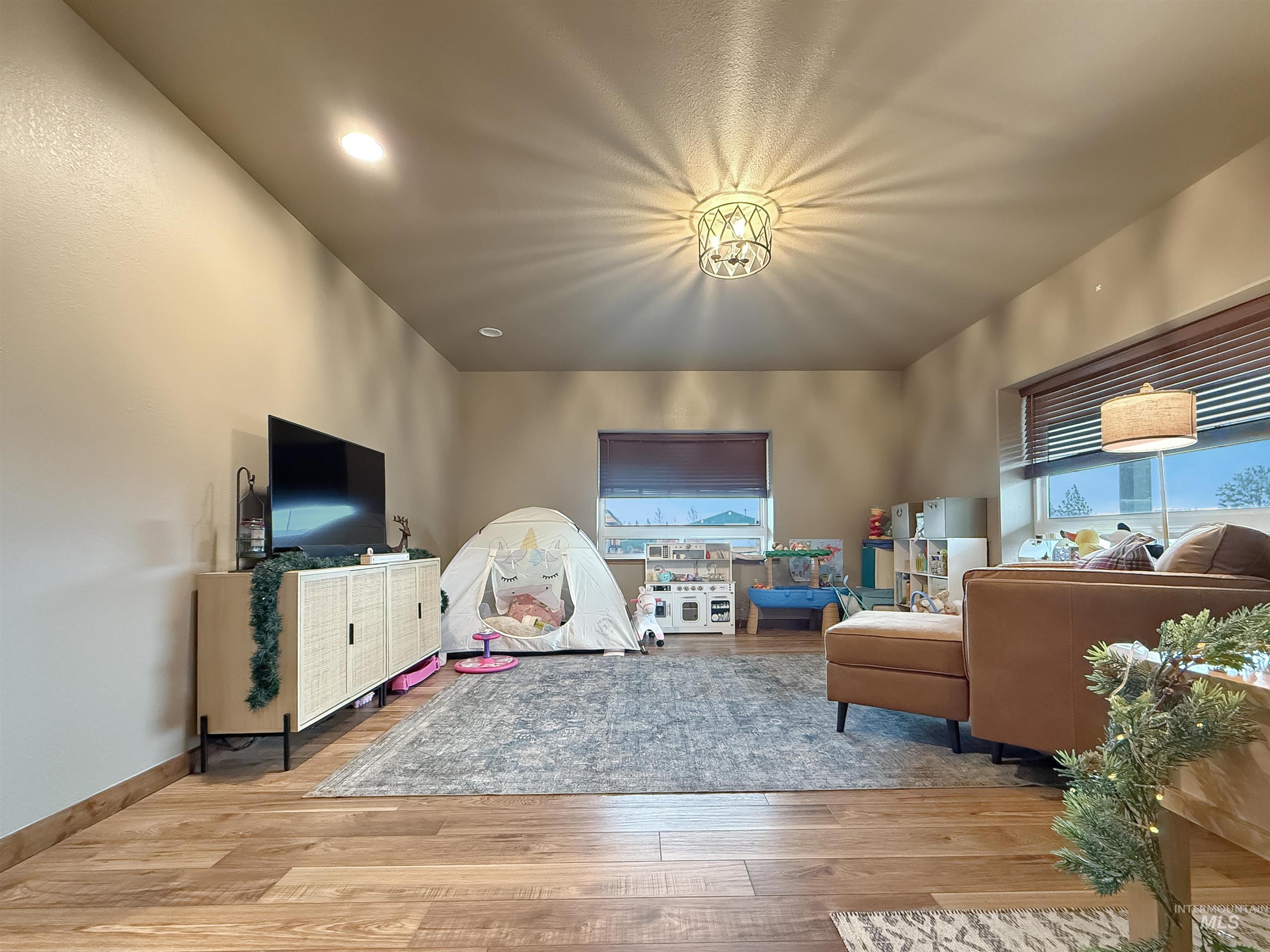 Living area featuring light wood-style floors and baseboards