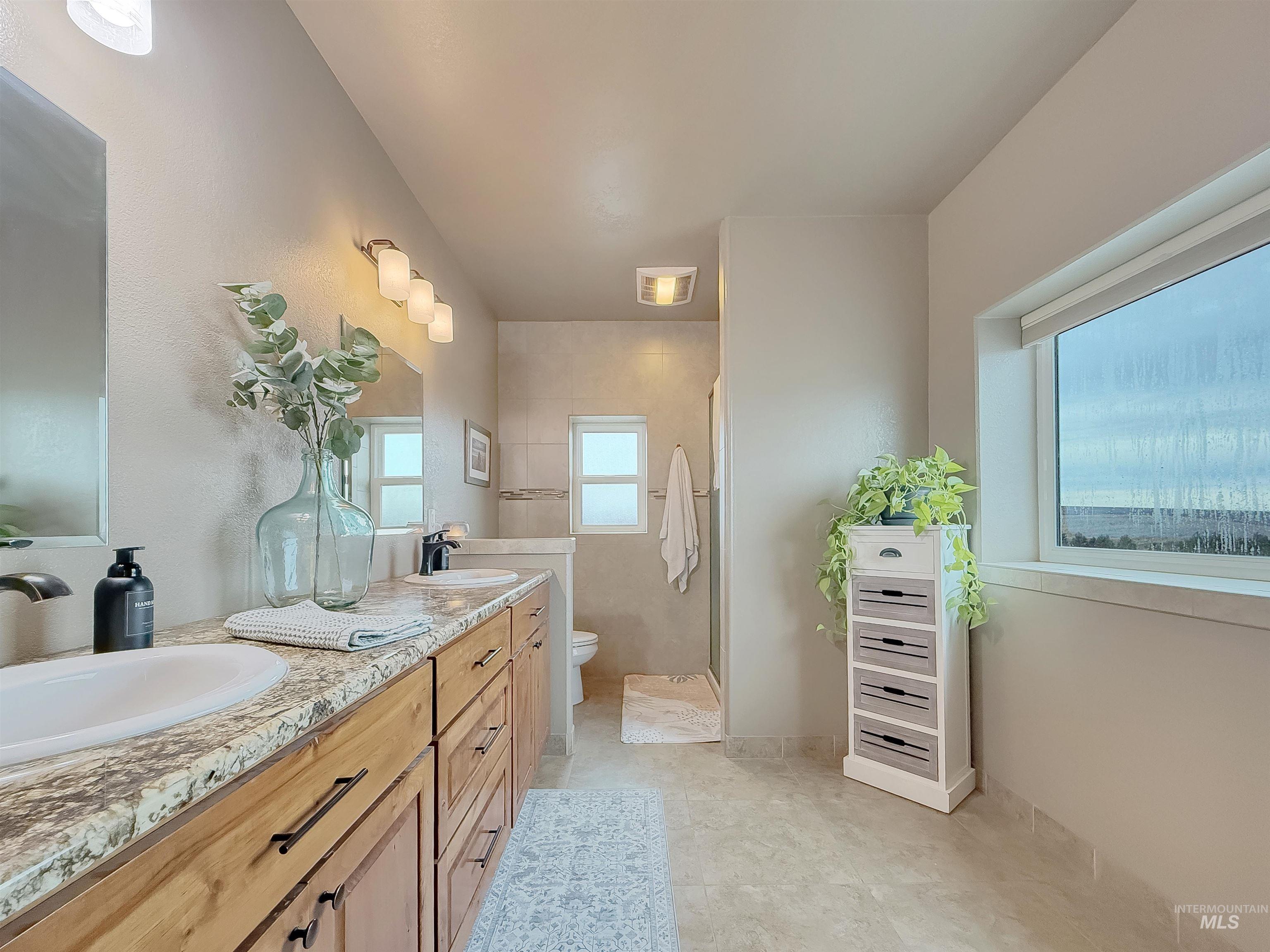 Bathroom with a shower stall and double vanity