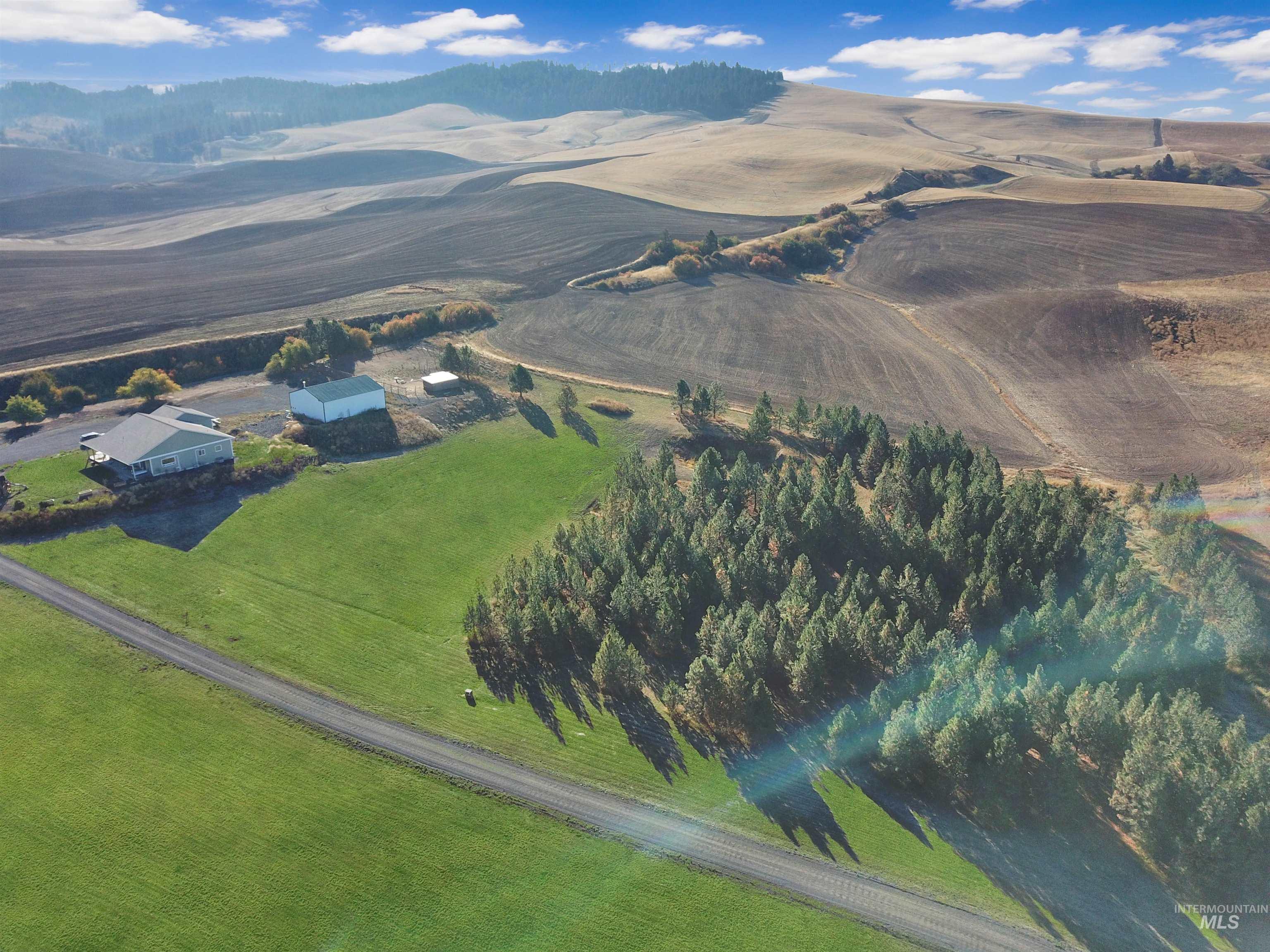 Aerial view of property and surrounding area featuring rural landscape