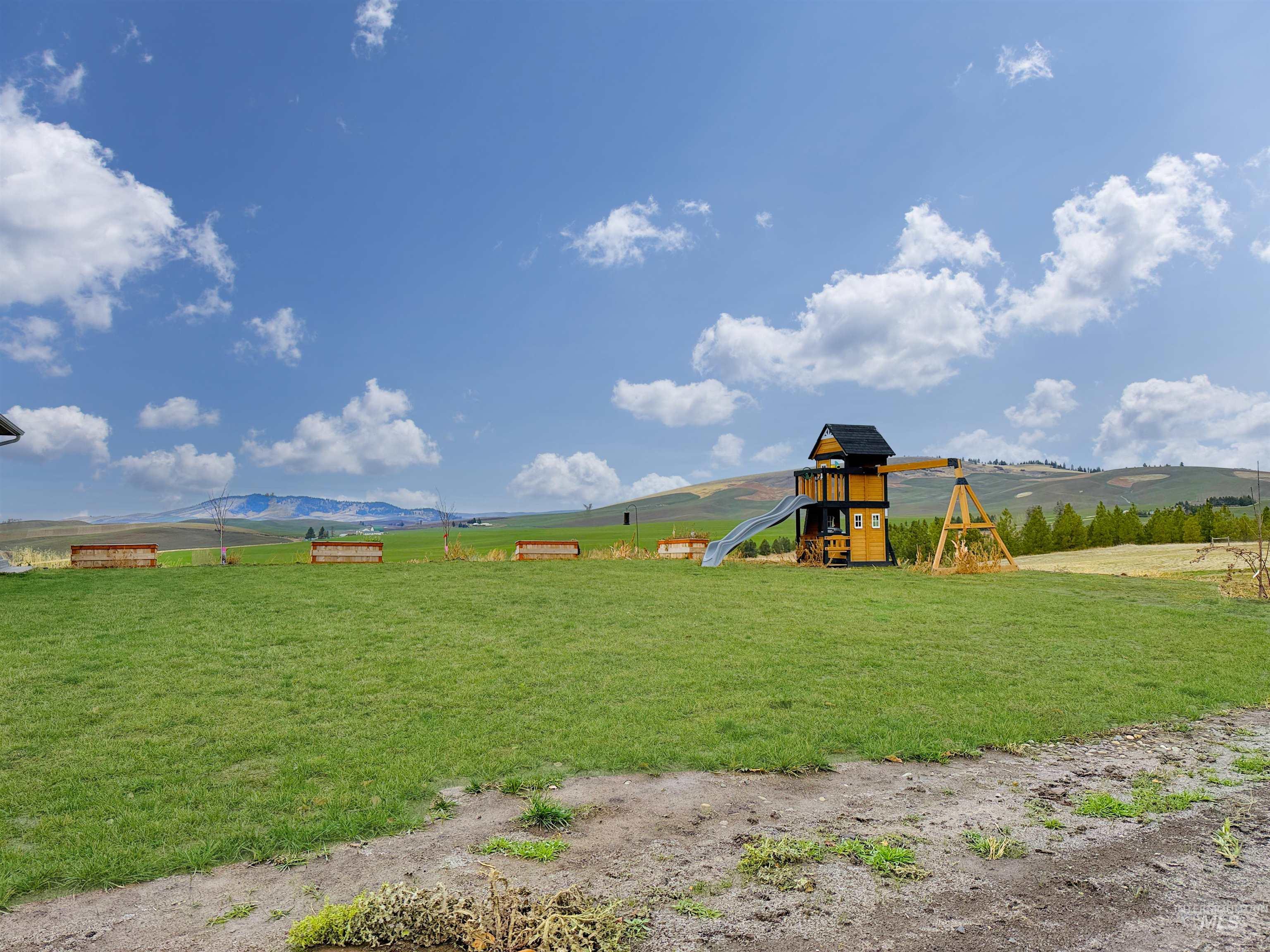 View of play area featuring a view of rural / pastoral area, a yard, and a mountain view