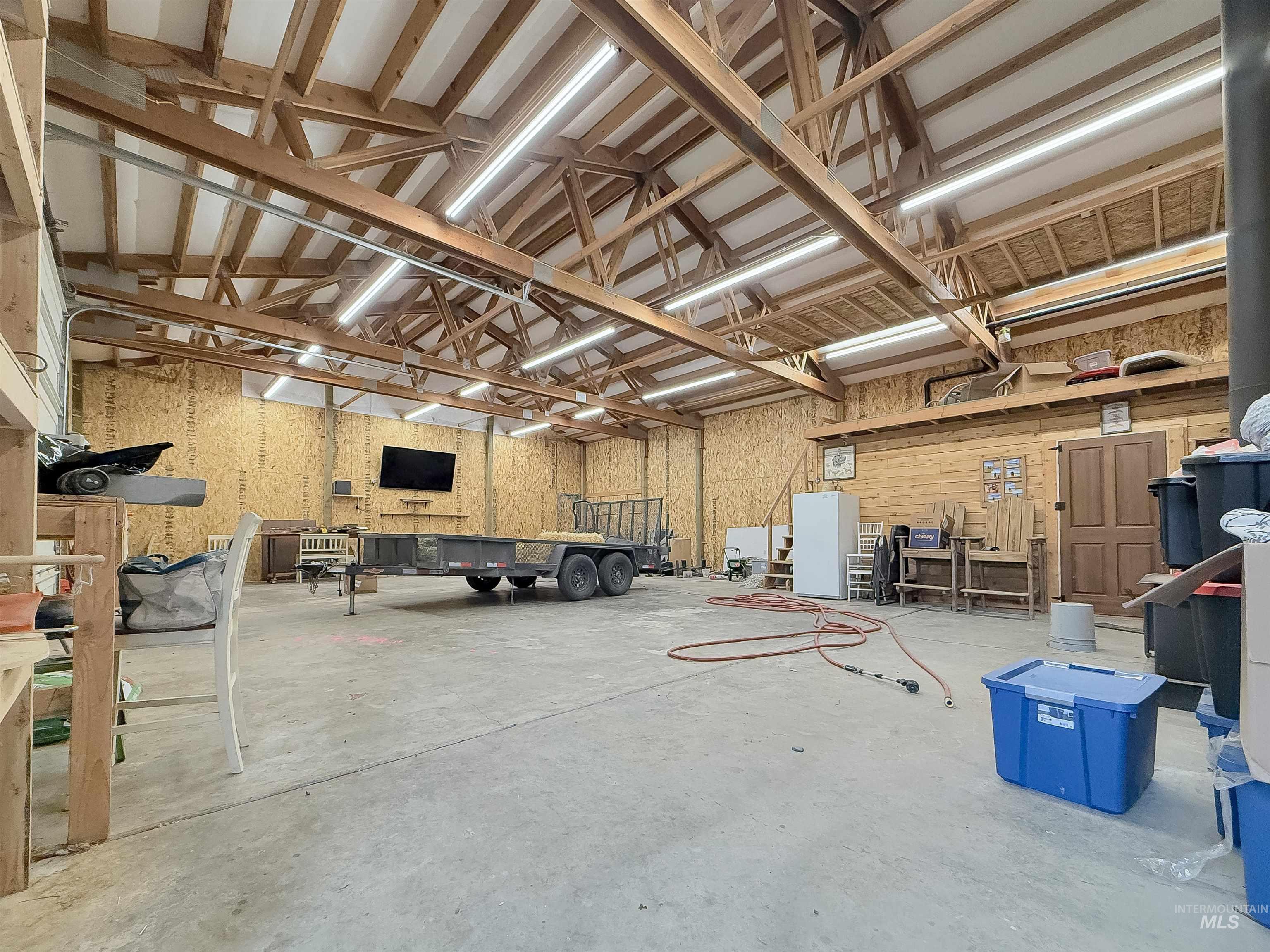 Misc room with a garage and a workshop area