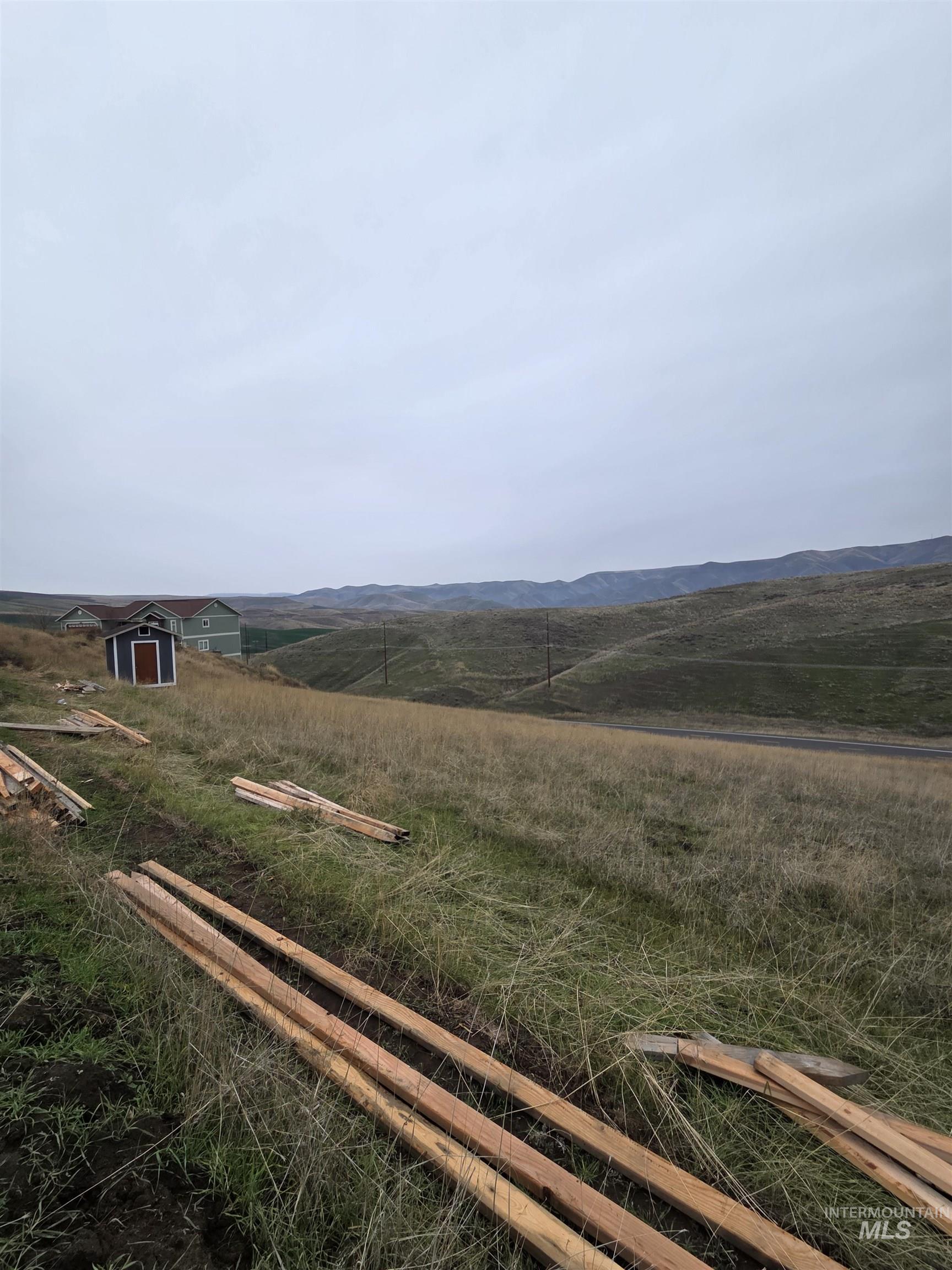 View of yard featuring a view of countryside and a storage shed