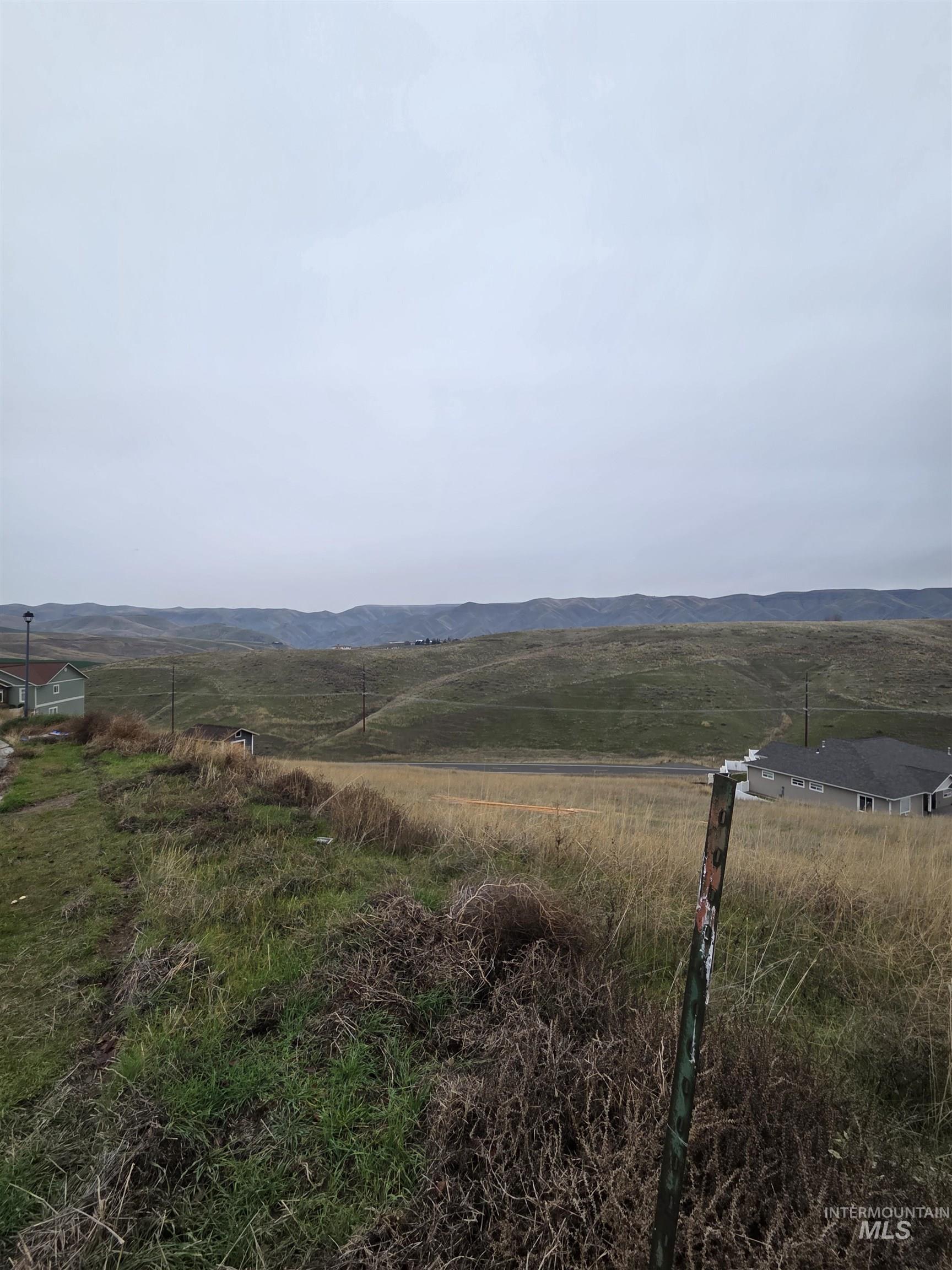 View of mountain backdrop featuring rural landscape