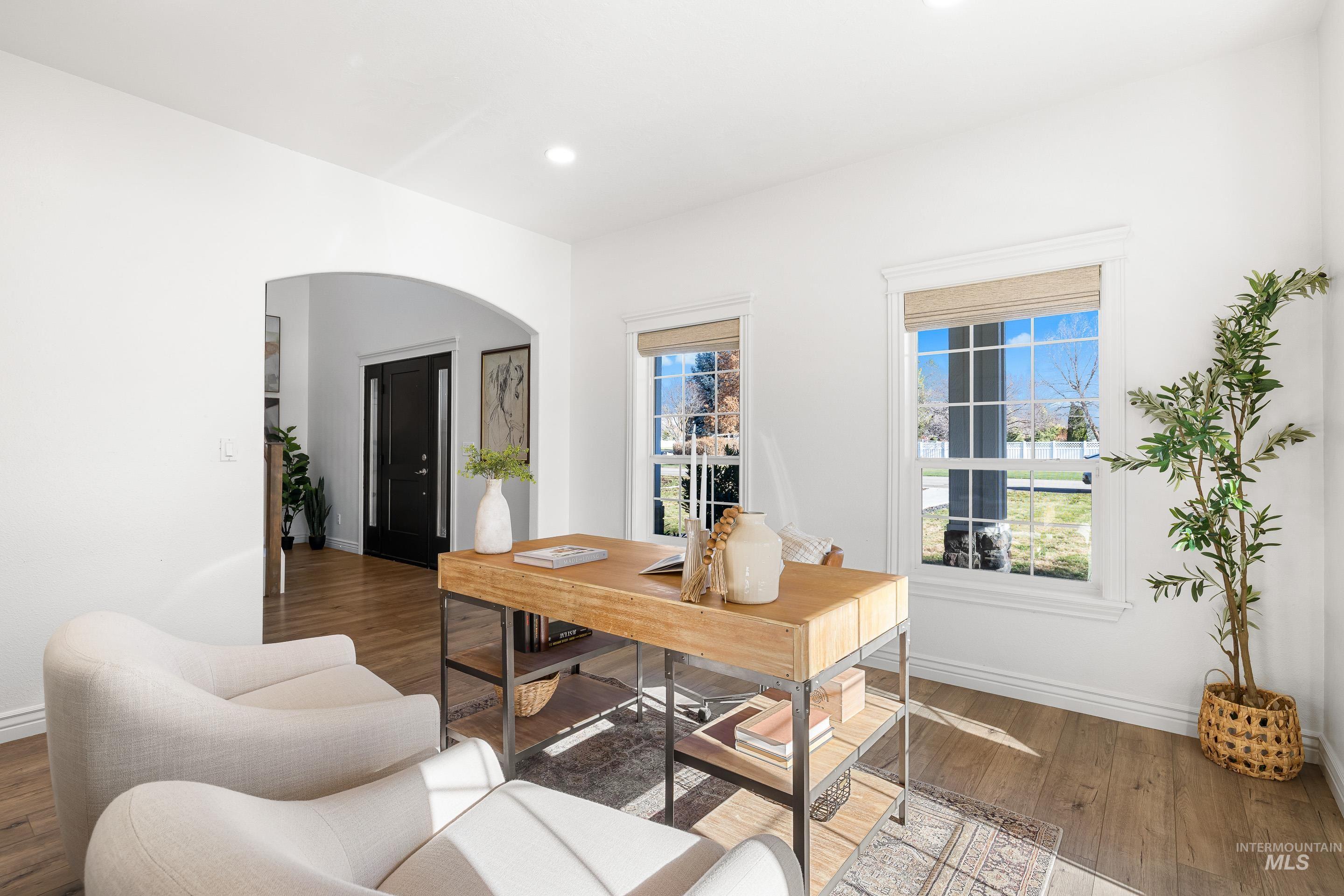 Office featuring arched walkways, hardwood / wood-style floors, and recessed lighting