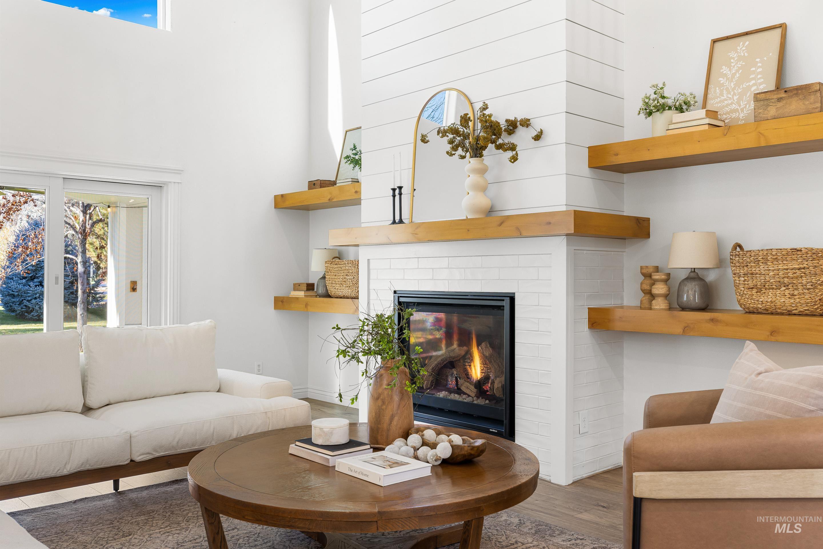 Living area featuring wood finished floors and a brick fireplace