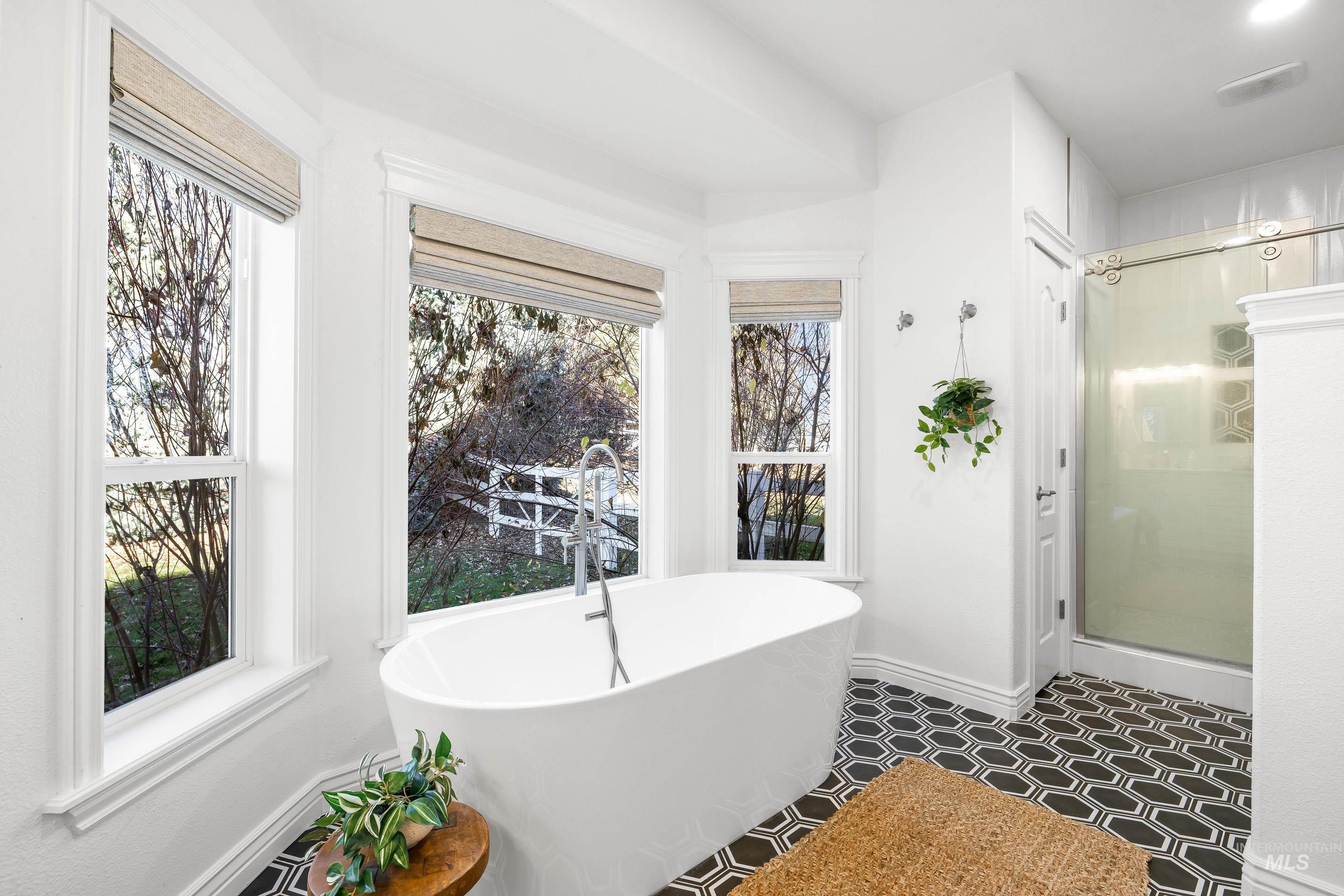 Full bathroom featuring a stall shower and a freestanding bath