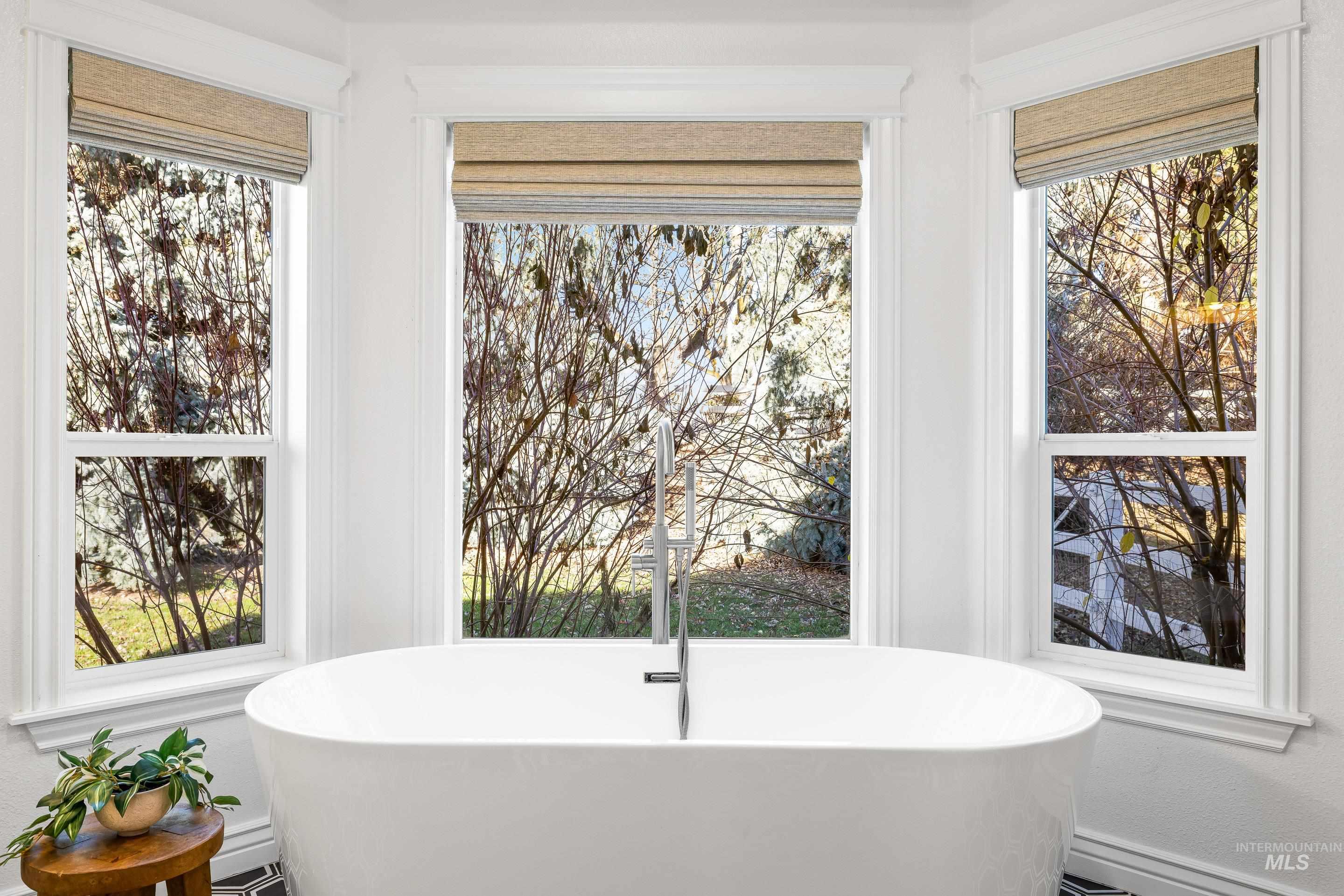 Bathroom featuring a freestanding tub and plenty of natural light