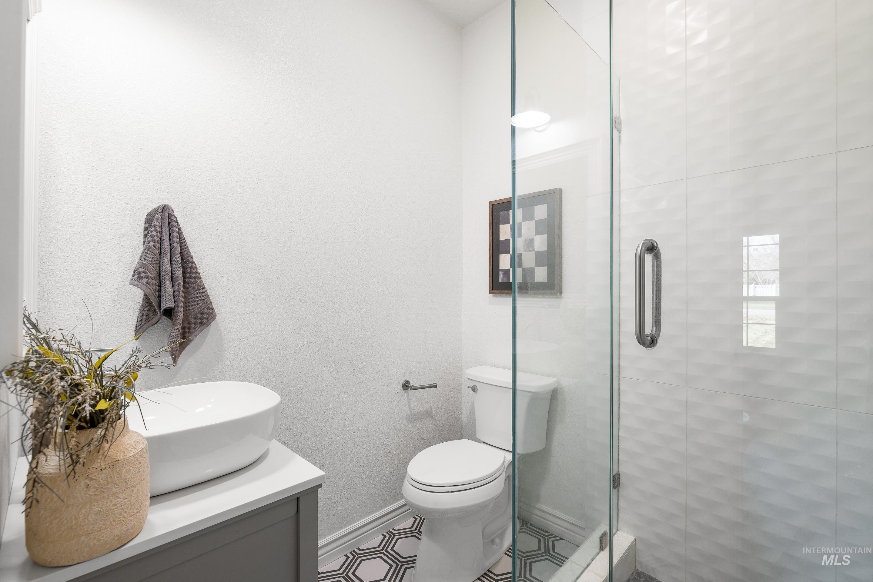 Full bathroom featuring vanity and a shower stall