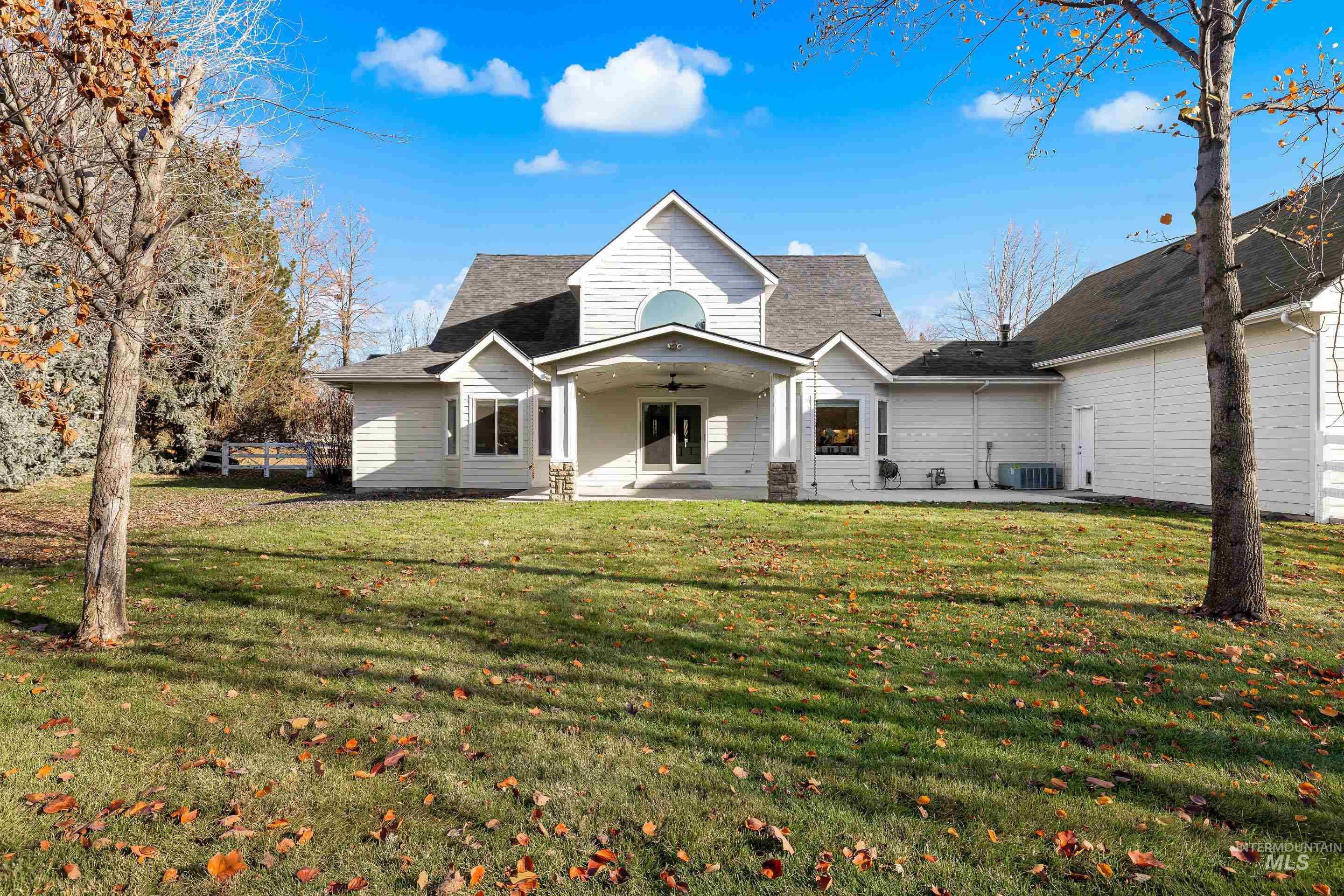 View of front facade featuring a patio, ceiling fan, and a front lawn
