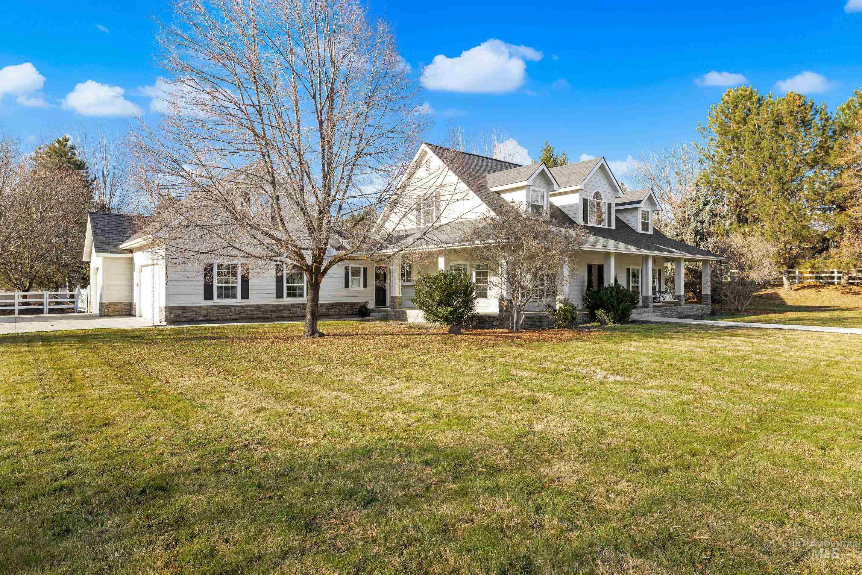 View of front of property with a porch and a garage