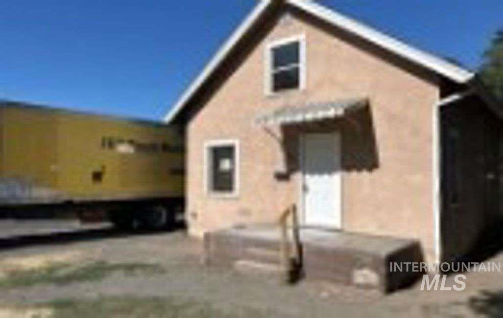 Rear view of property with stucco siding