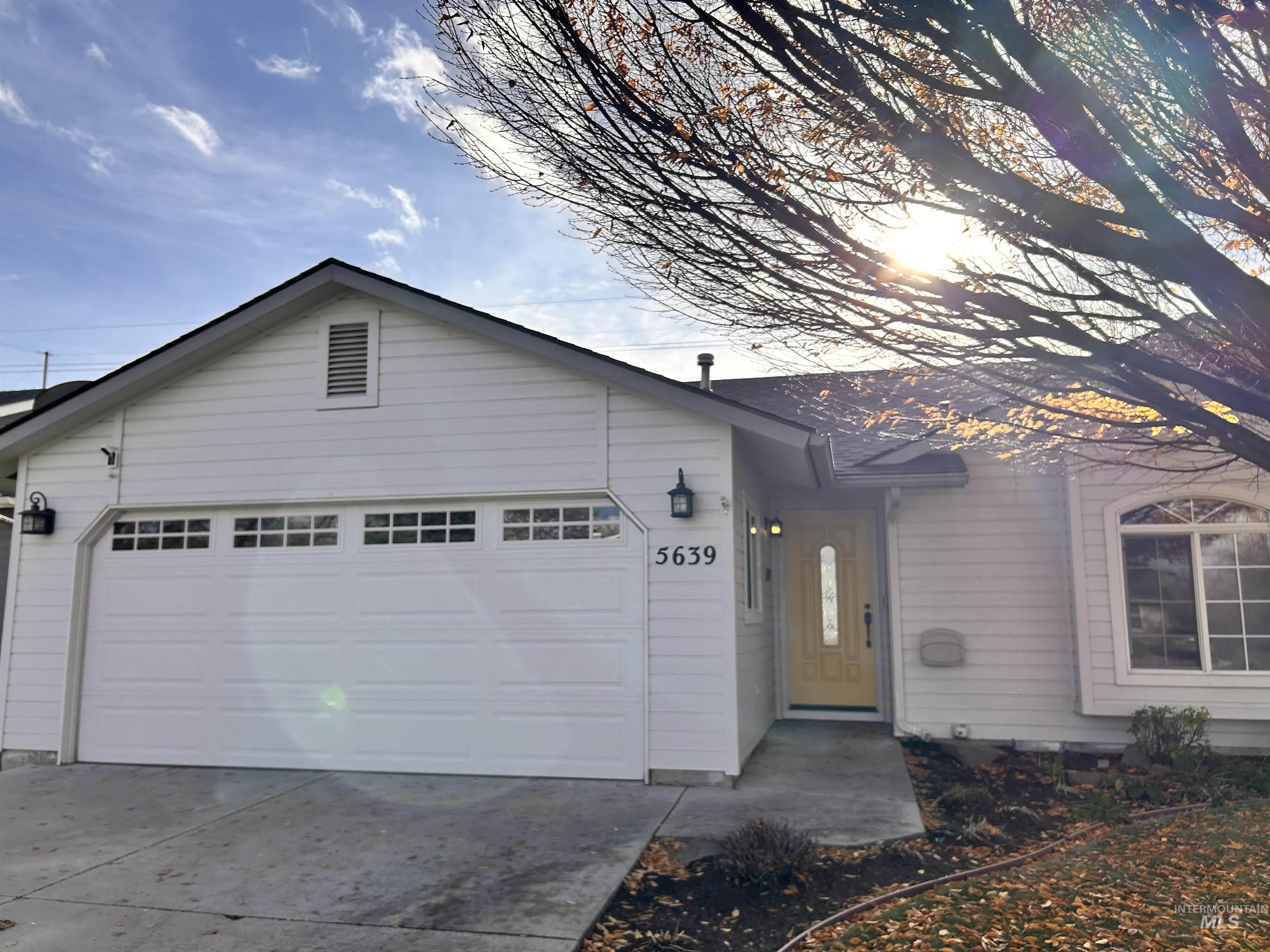 Ranch-style home featuring driveway and an attached garage