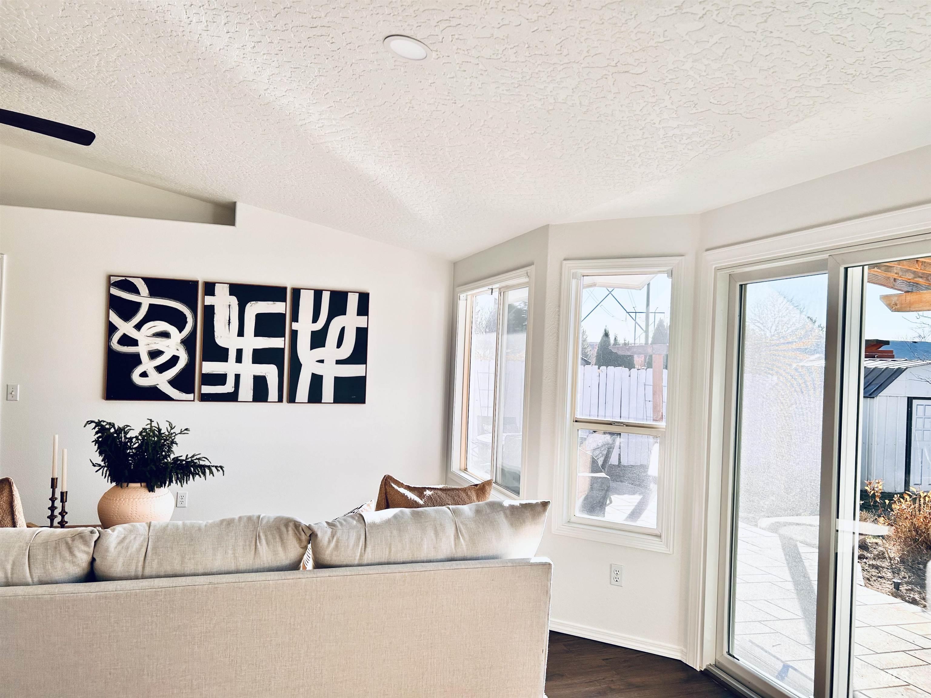 Living area with a textured ceiling and dark wood-style floors