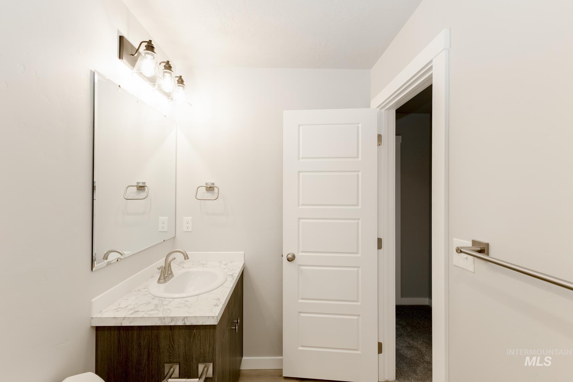 Bathroom featuring vanity and baseboards