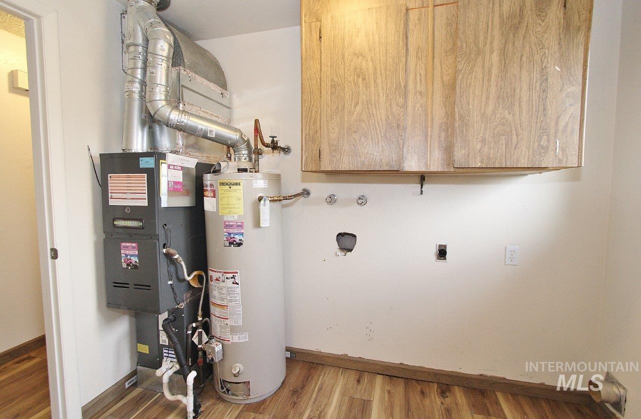 Utility room with gas water heater and heating unit