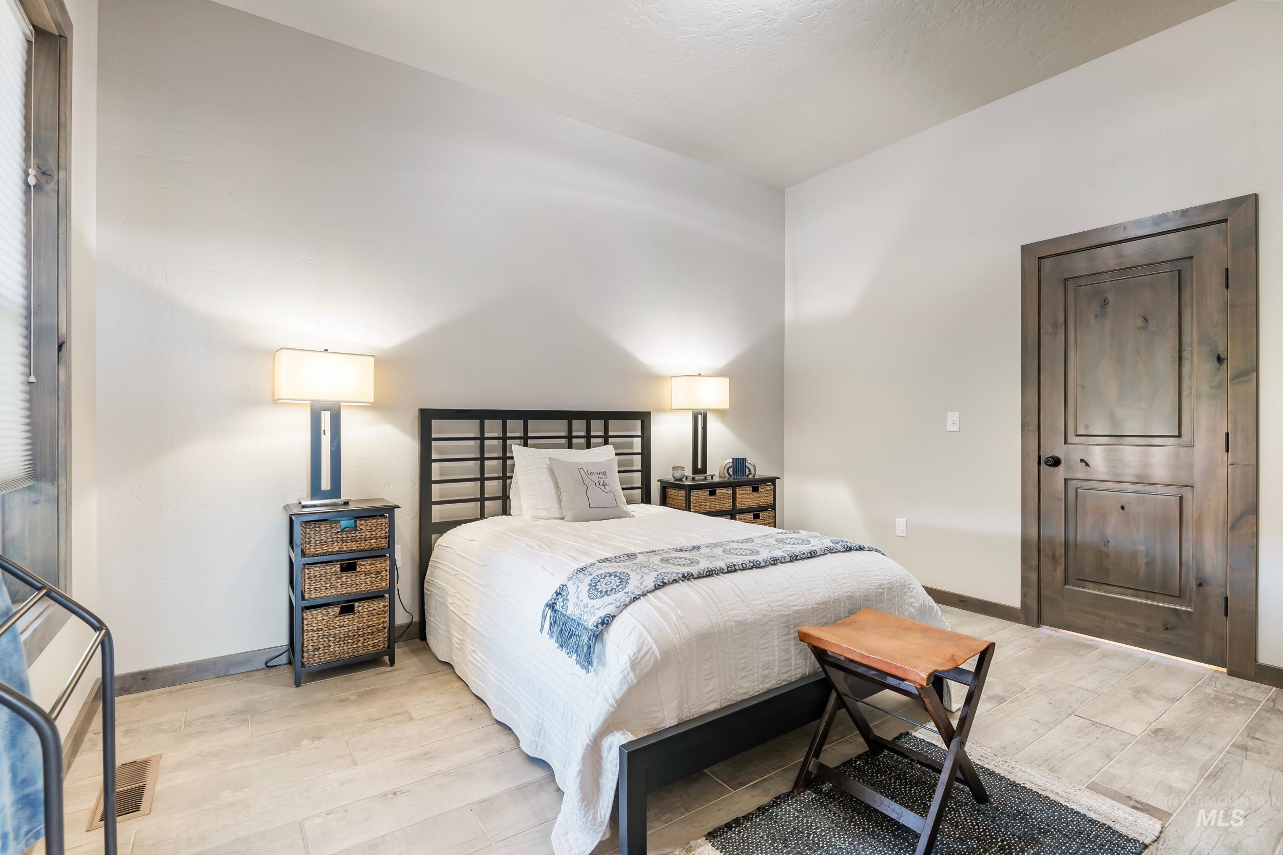 Bedroom featuring light wood finished floors and baseboards
