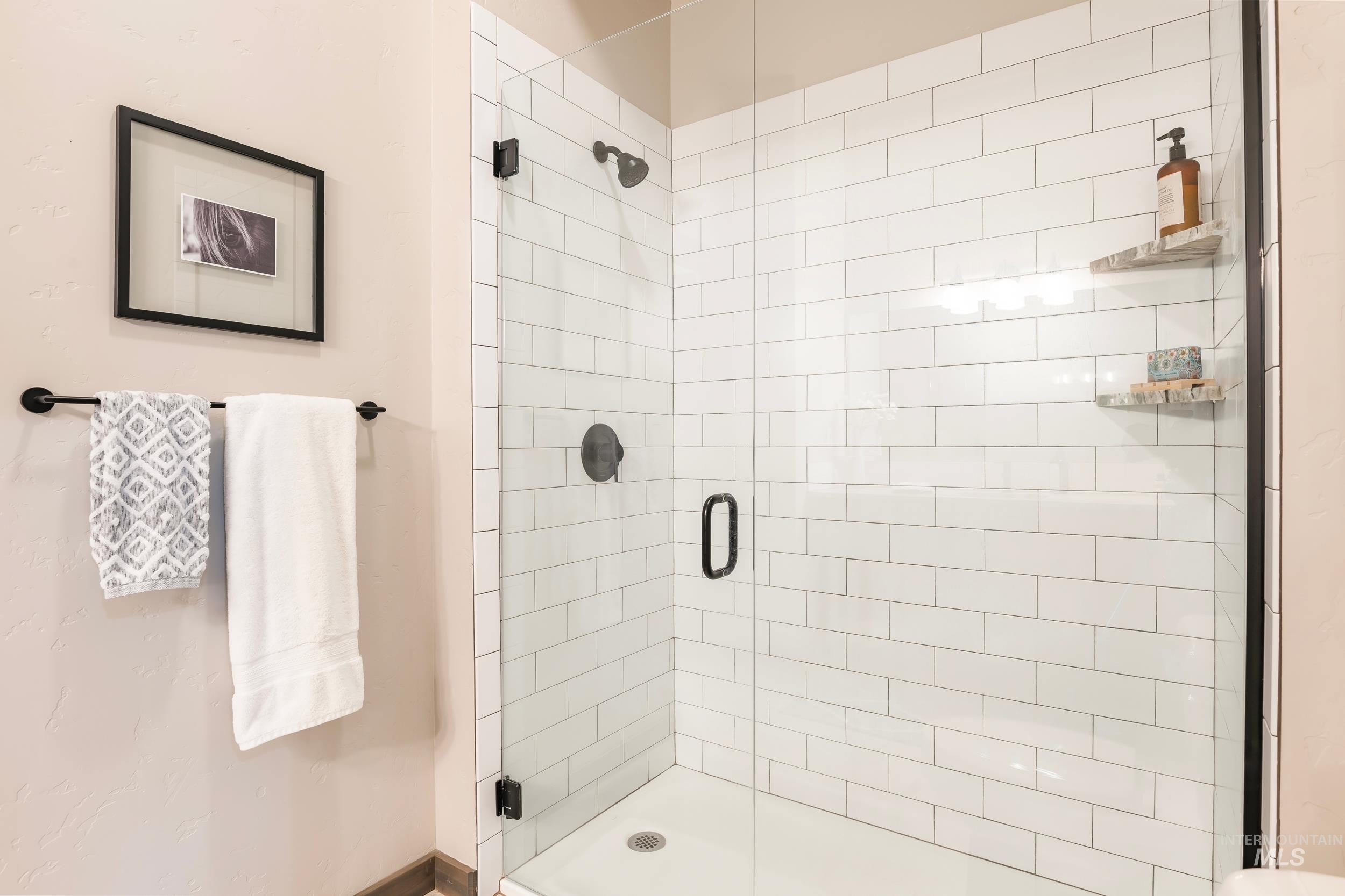 Full bathroom featuring a shower stall