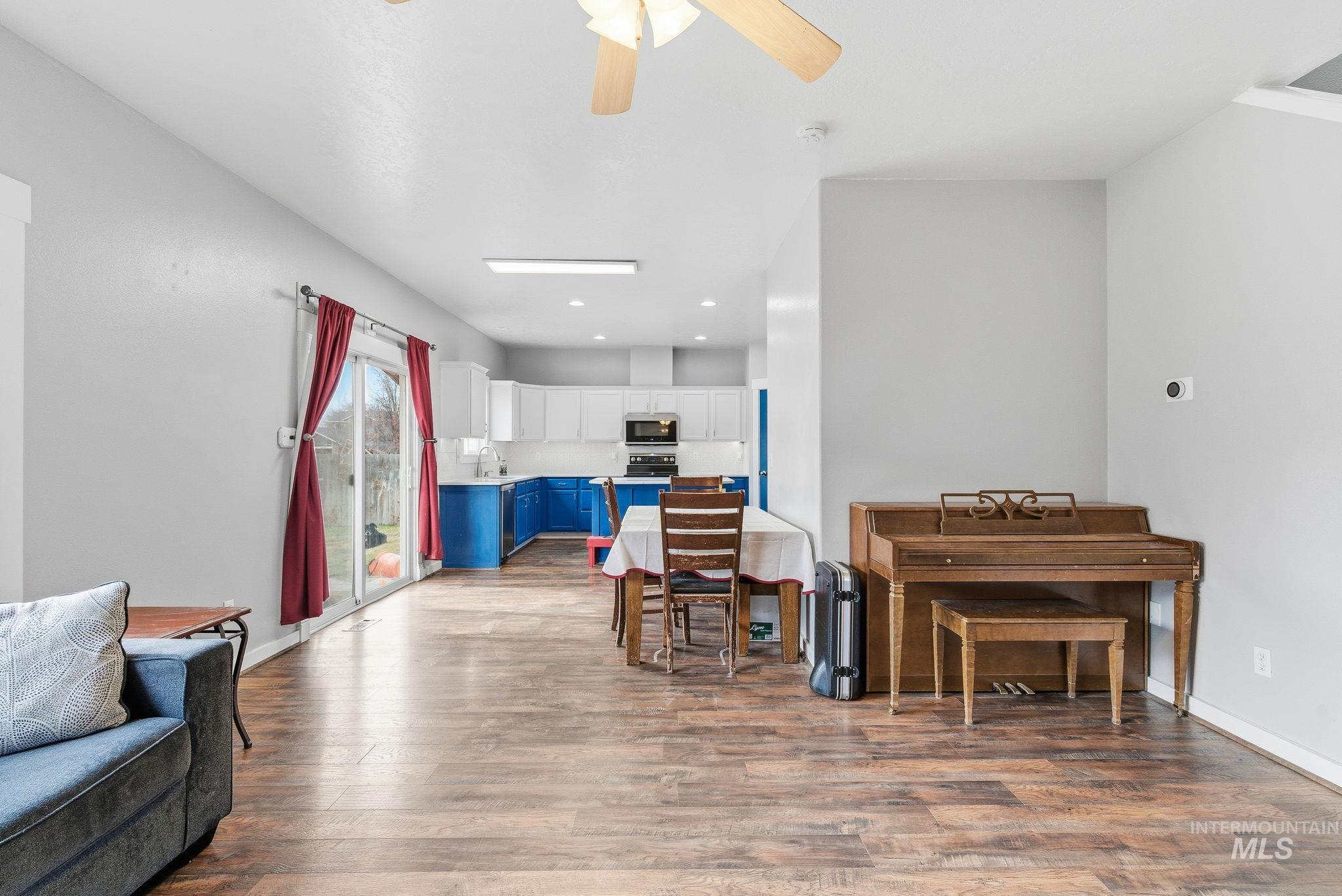Living room featuring light wood-style flooring, ceiling fan, and recessed lighting