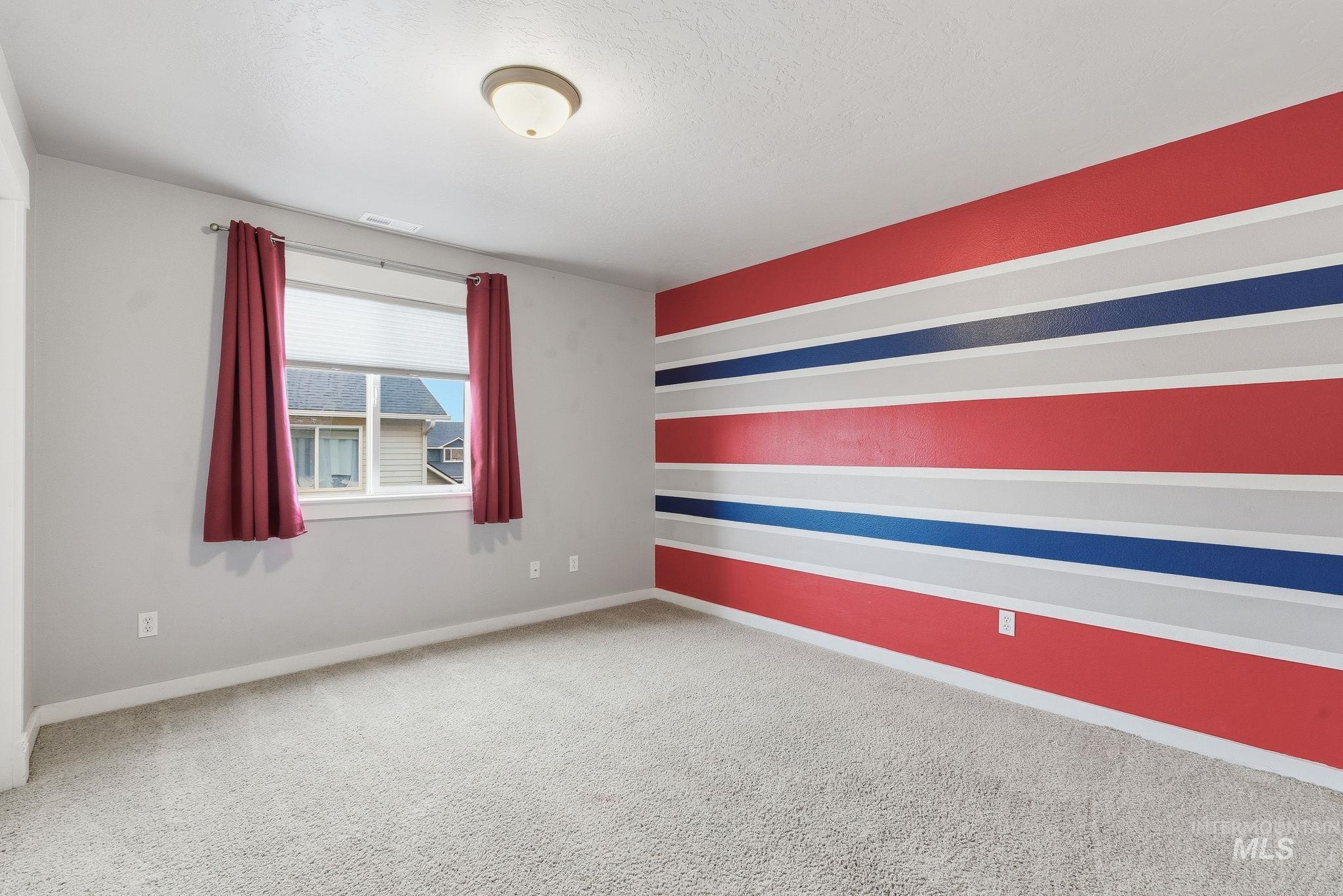Unfurnished room featuring light colored carpet and baseboards