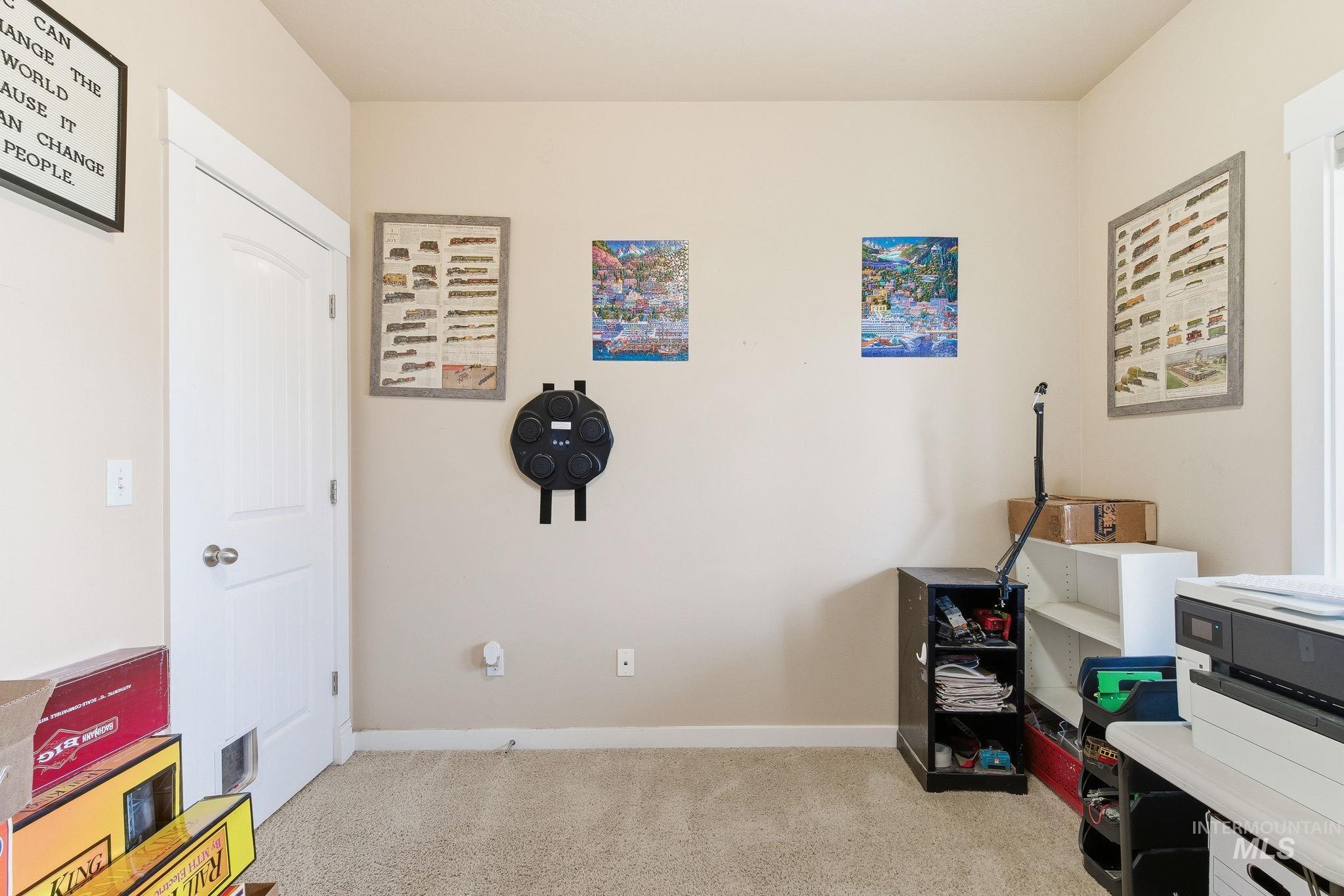 Rec room featuring light colored carpet and baseboards