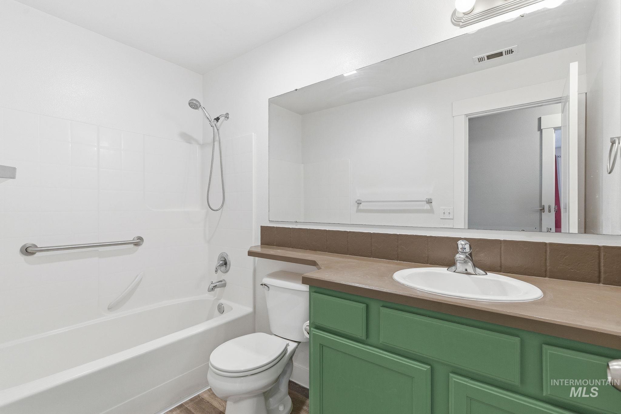 Bathroom with vanity and shower / washtub combination