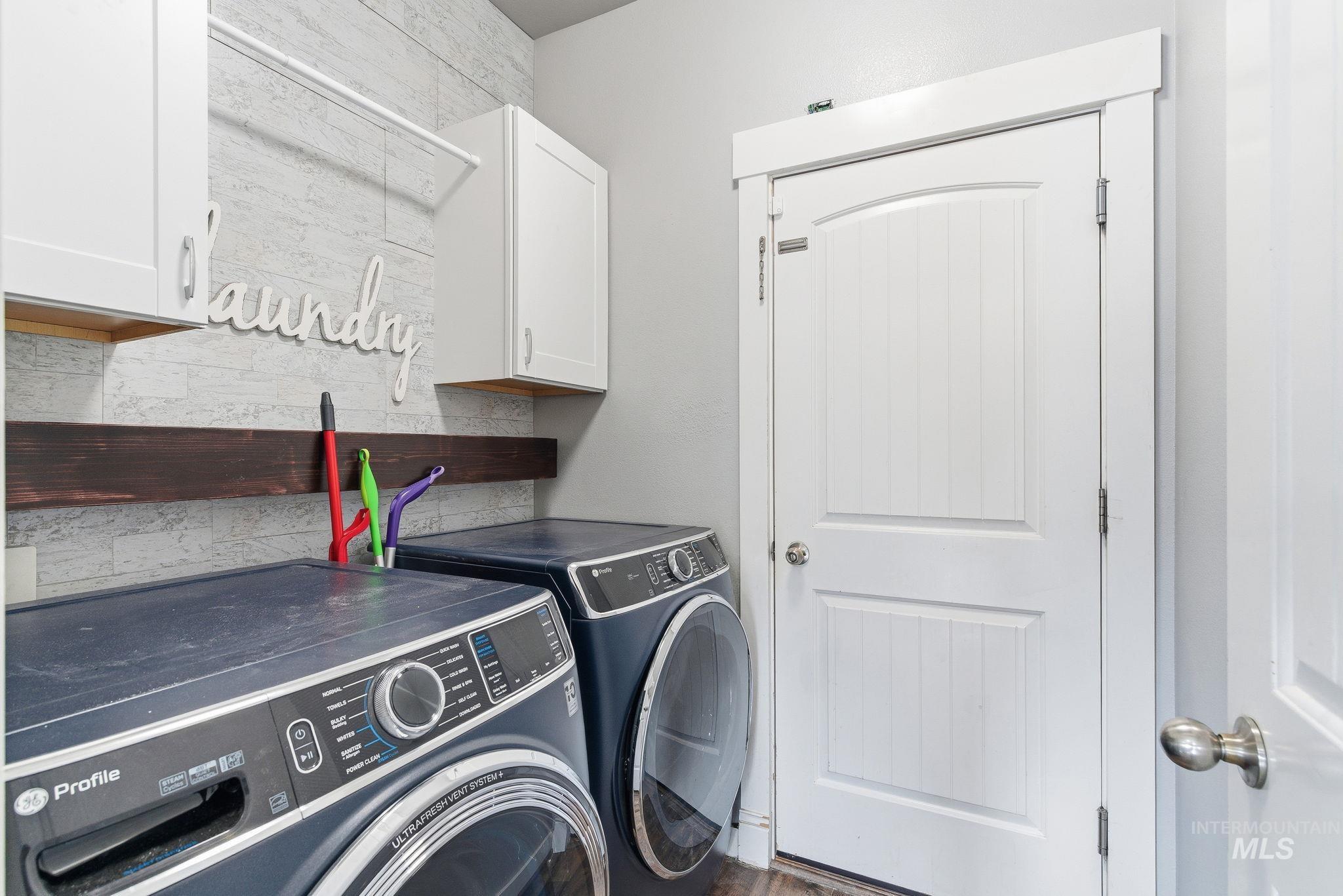 Laundry area featuring cabinet space and washing machine and dryer
